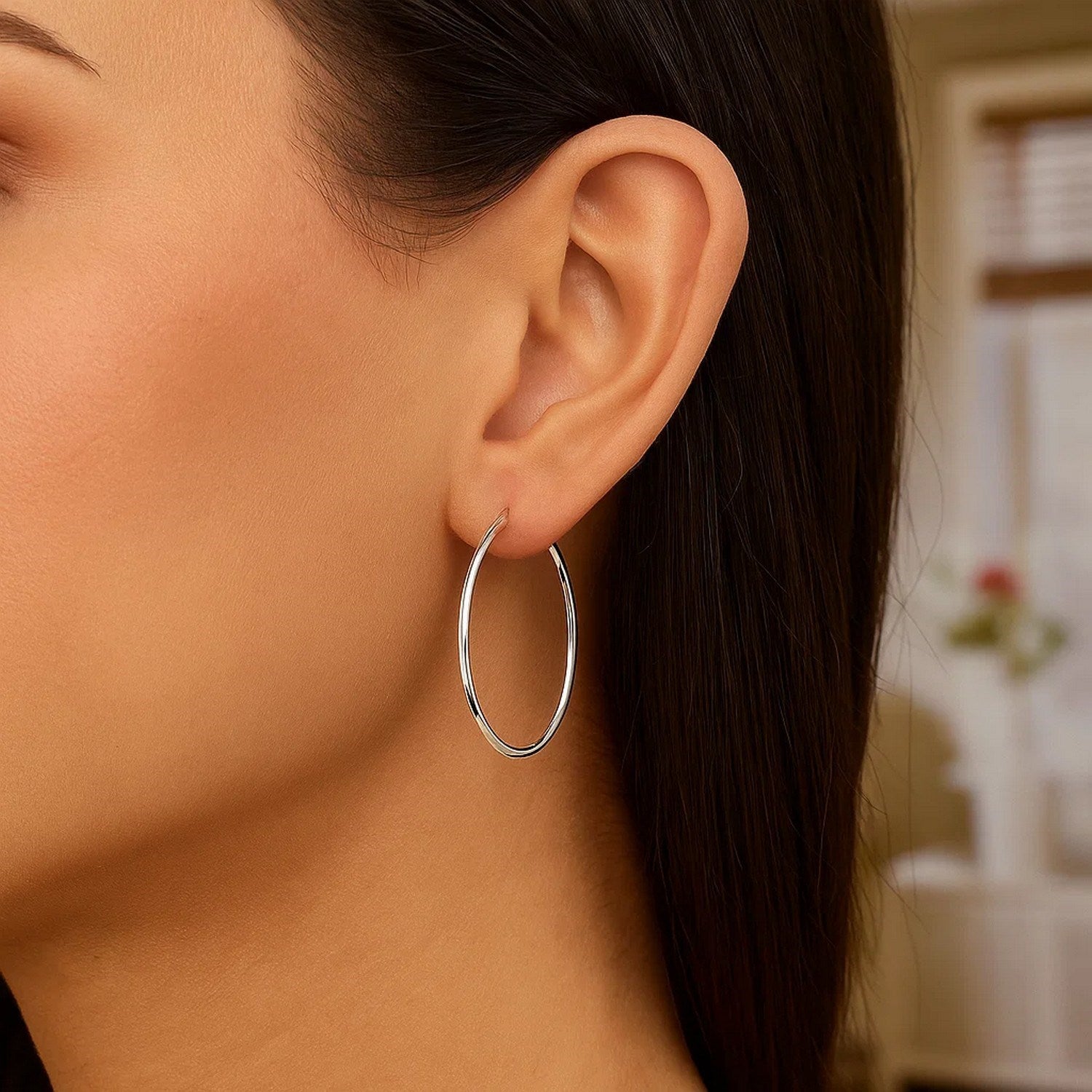 Polished 10k white gold hoop earrings featuring a modern design, perfect for elegant occasions.