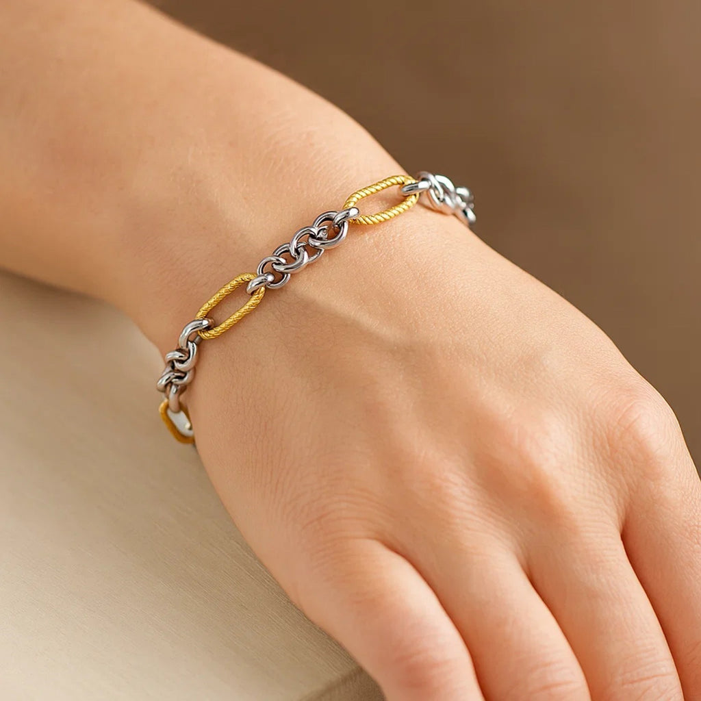 14k two-tone gold bracelet featuring cable textured oval and round links, embodying classic elegance and luxury.