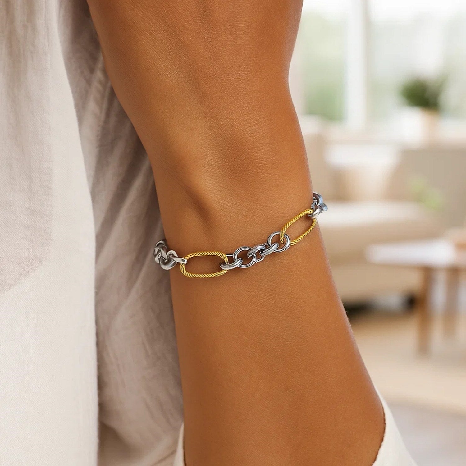 14k two-tone gold bracelet featuring cable textured oval and round links, embodying classic elegance and luxury.