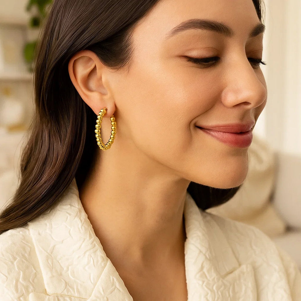 14k yellow gold textured polished hoop earrings with a modern design, perfect for elevating any luxury jewelry collection.