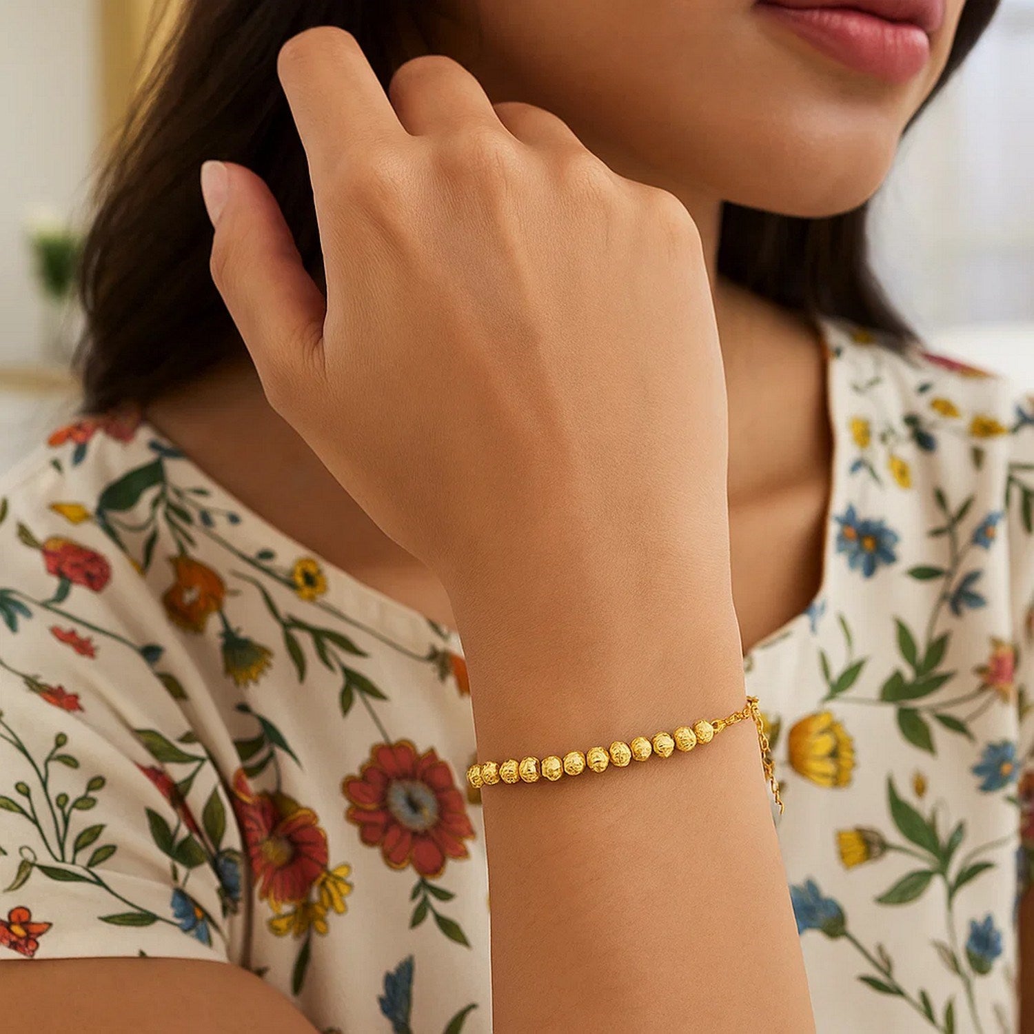 Diamond cut bead bracelet in 14k yellow gold featuring modern design and sparkling diamond accents.