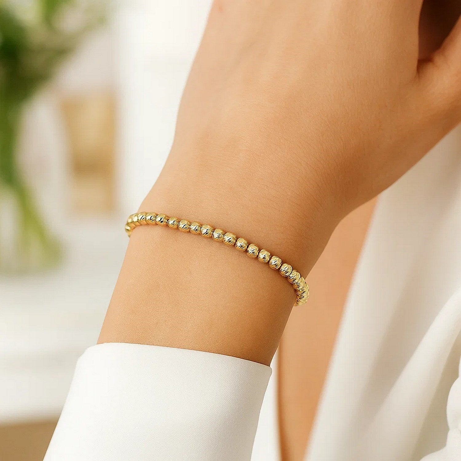 Diamond cut bead bracelet in 14k yellow gold, featuring modern design and sparkling diamond accents.