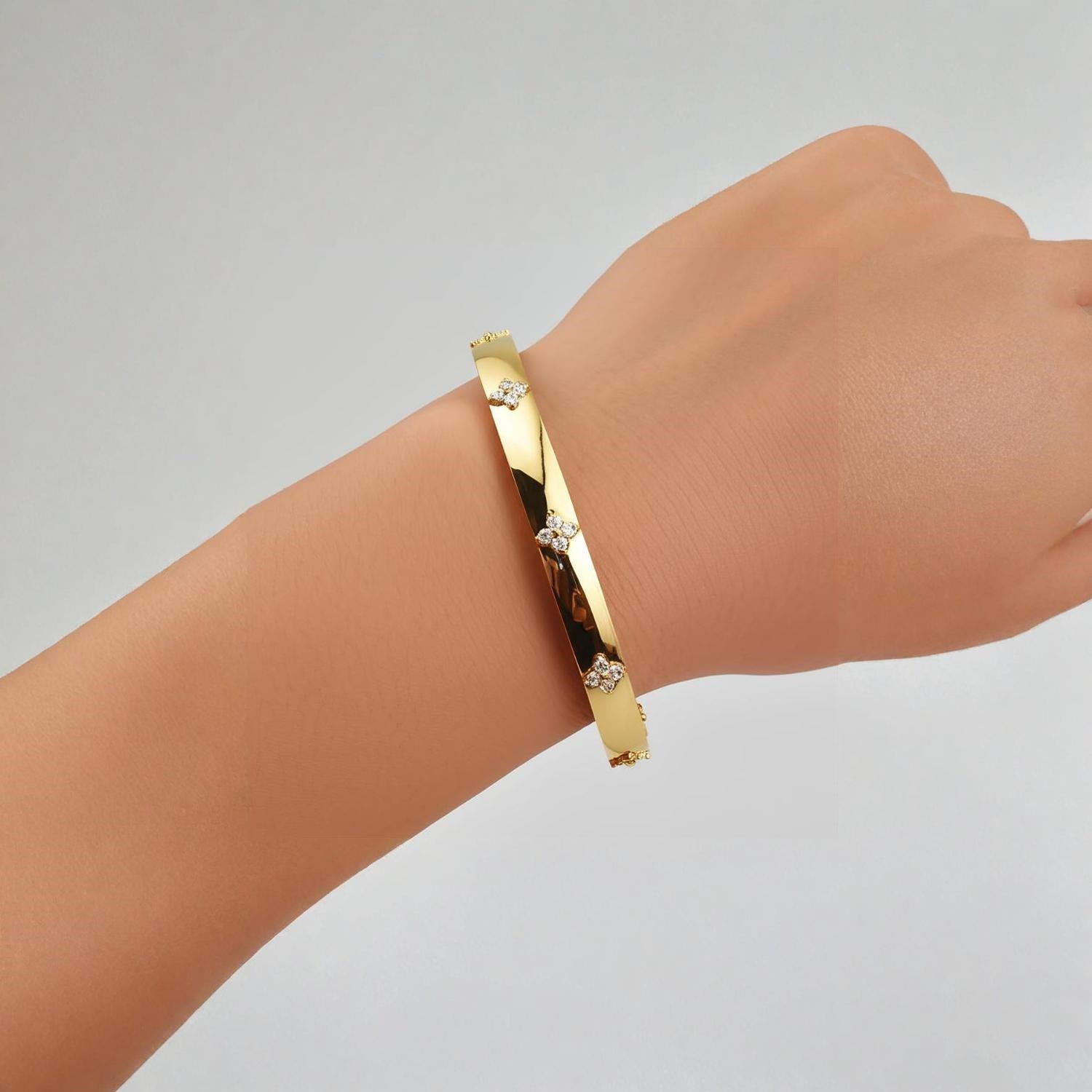 14k yellow gold trilogy diamond bangle featuring a classic prong setting and elegant round diamonds, 5.40 mm wide.