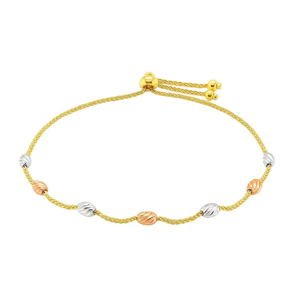 14k tri-color gold textured oval station lariat bracelet featuring elegant links and shimmering diamonds.