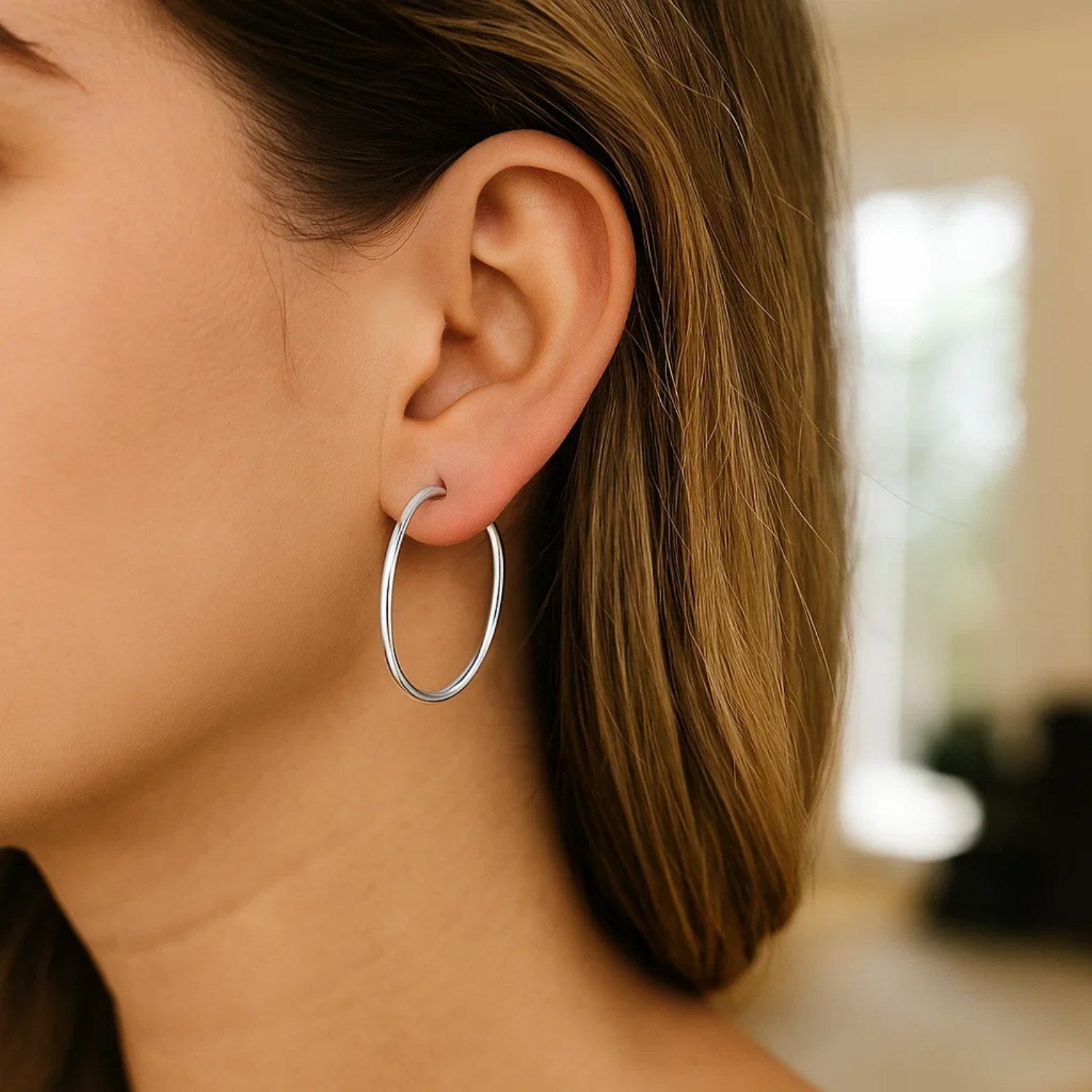 Polished 14k white gold hoop earrings showcasing a classic design, perfect for elegant everyday wear.