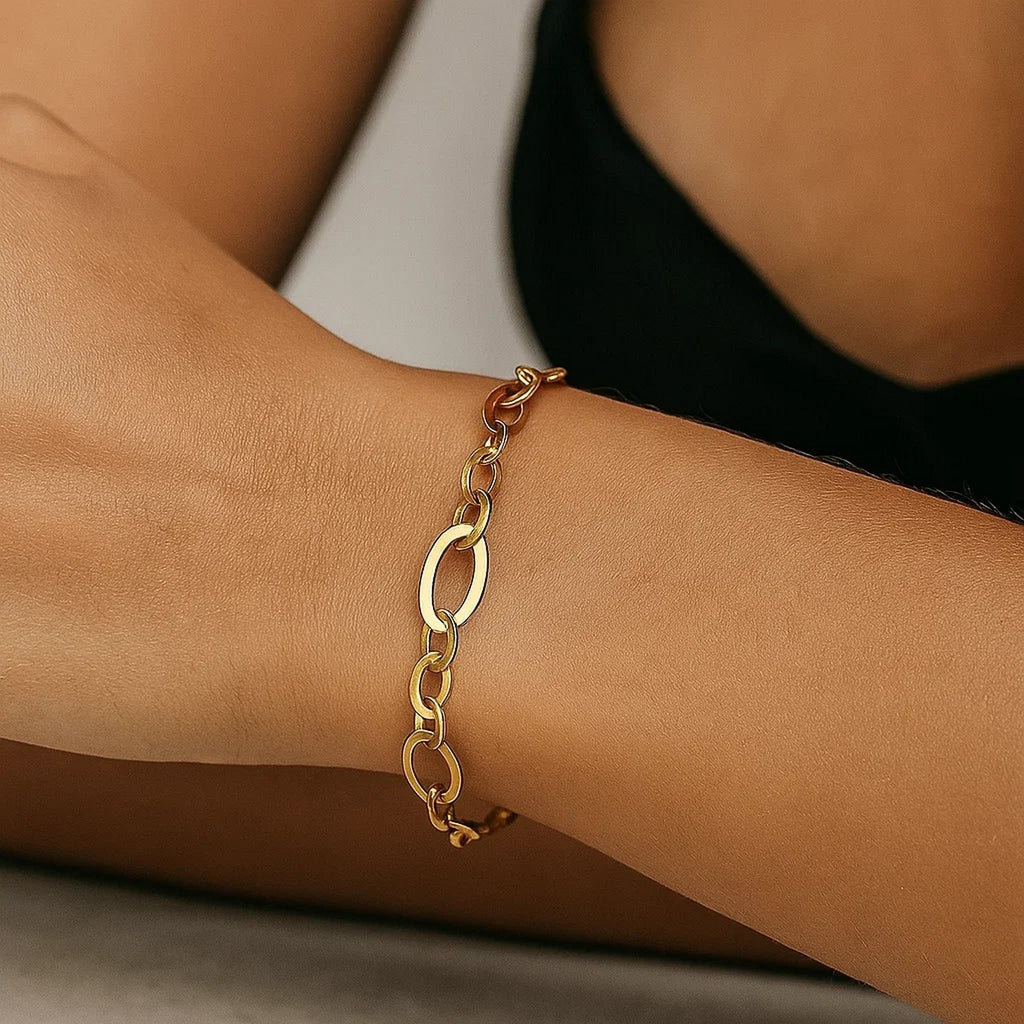 Large flat oval link bracelet in elegant 14k yellow gold, showcasing a refined, timeless design.
