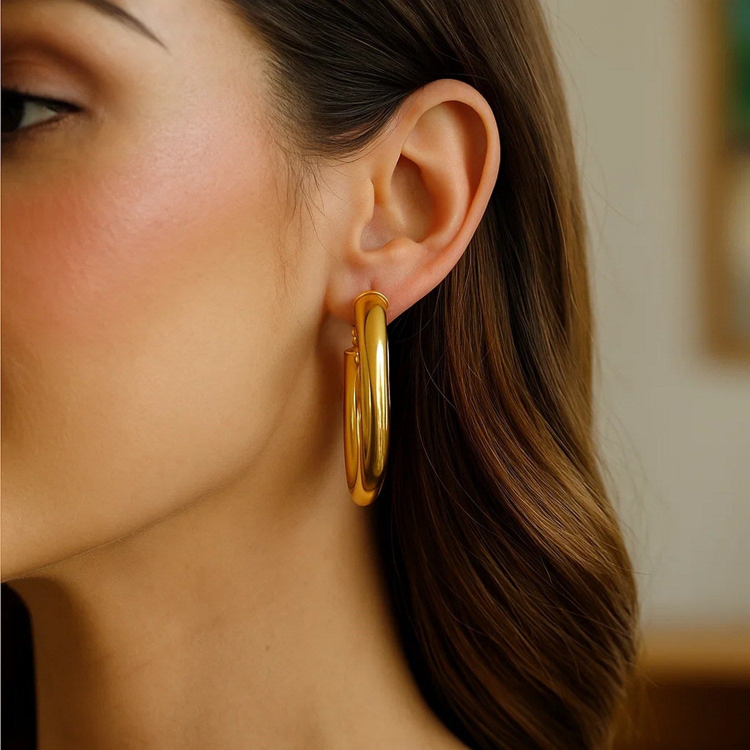 14k yellow gold textured oval hoop earrings showcasing modern elegance and refined craftsmanship.