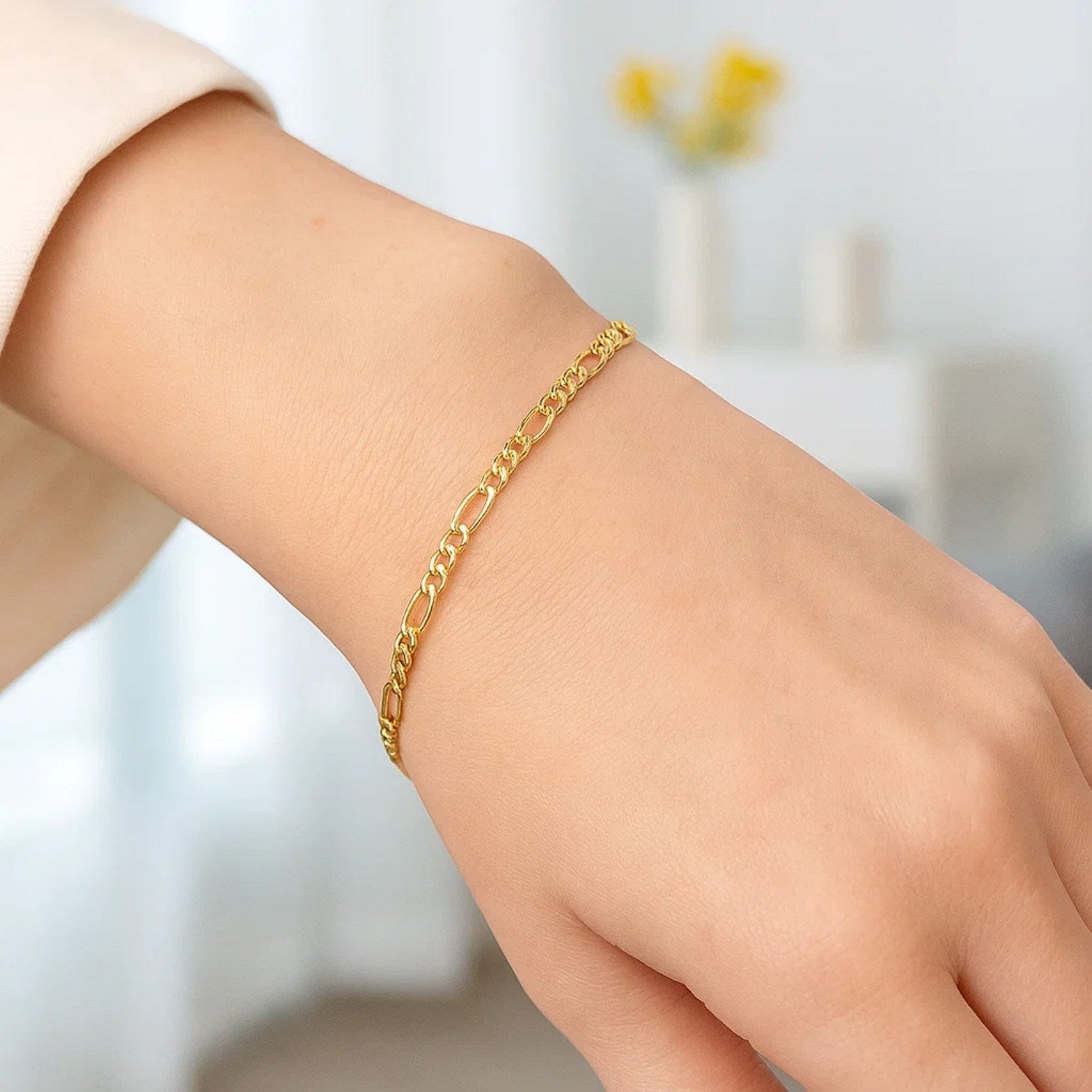 14k yellow gold Figaro bracelet featuring elegant links, perfect for contemporary luxury styling.