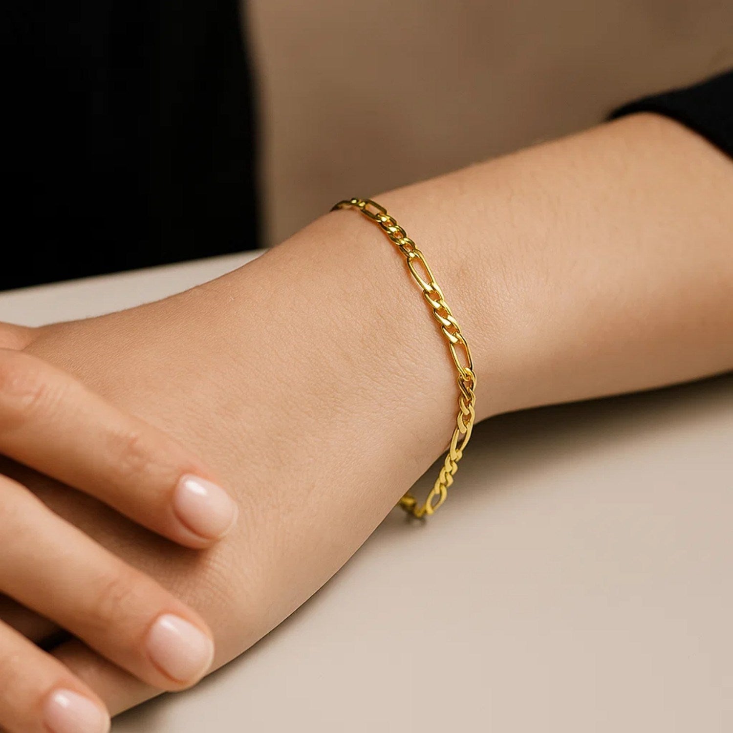 14k yellow gold Figaro bracelet featuring elegant links in a contemporary design, perfect for luxury jewelry lovers.