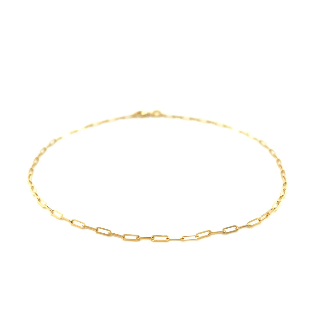 Elegant 14k yellow gold fine paperclip anklet featuring a delicate chain design, perfect for layering or solo wear.