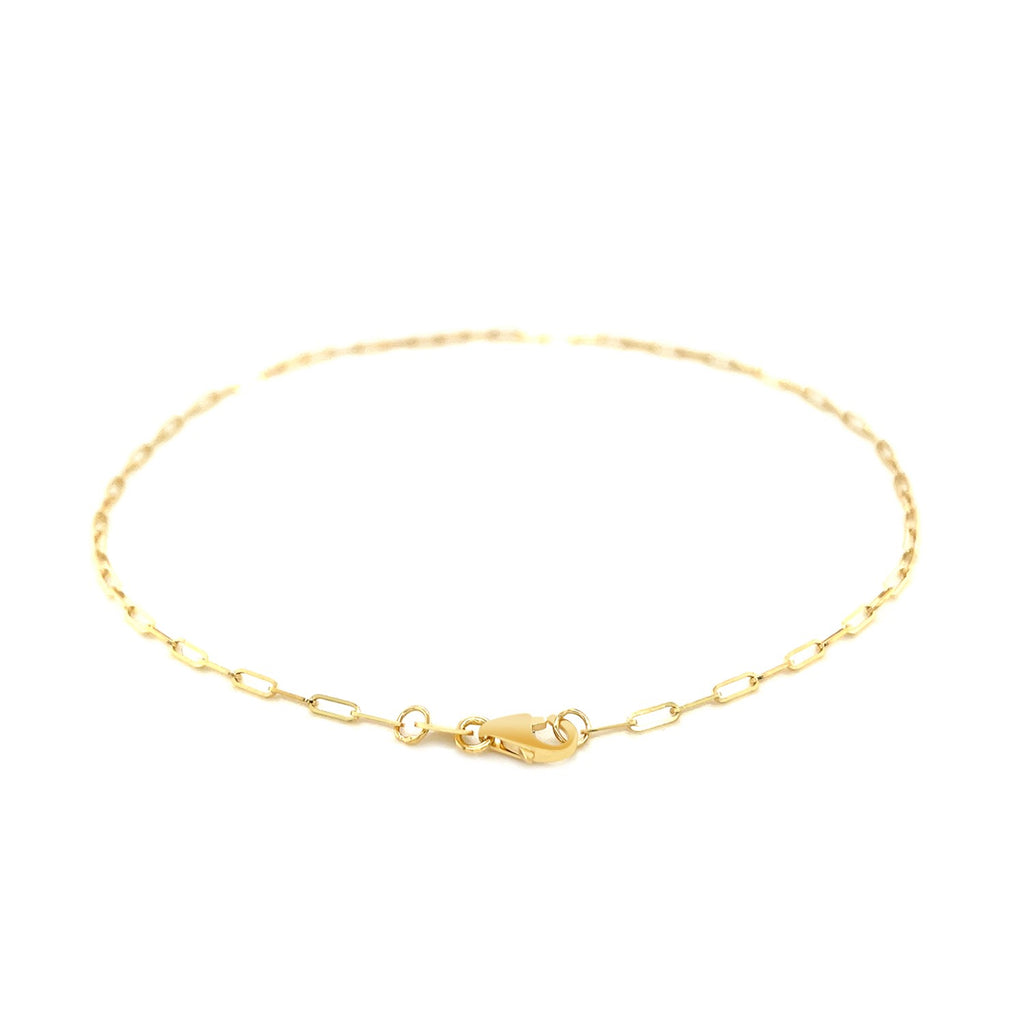 Elegant 14k yellow gold fine paperclip anklet featuring a delicate chain design, perfect for layering or solo wear.