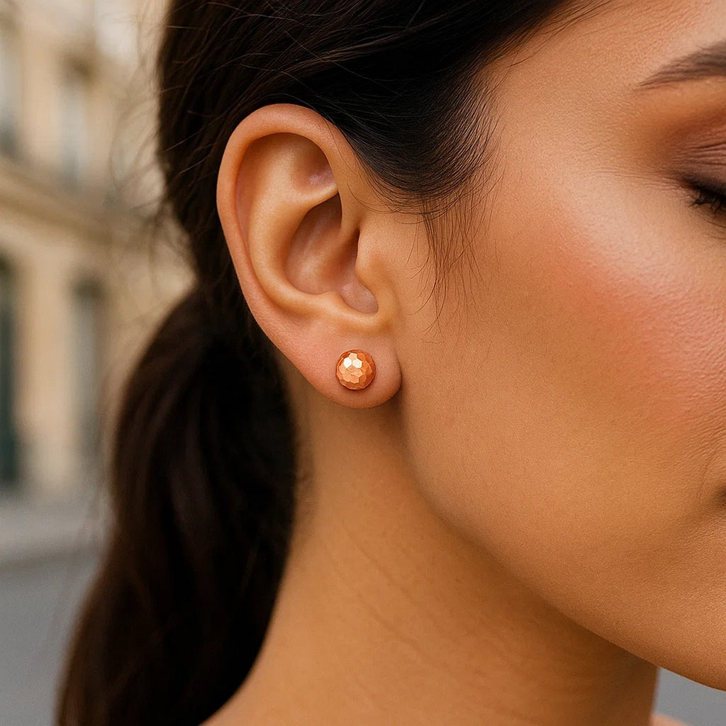 14k rose gold faceted round stud earrings showcasing a modern design with elegant simplicity and timeless appeal.