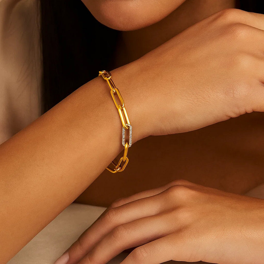 14k yellow gold paperclip chain bracelet featuring a diamond link, showcasing modern elegance and luxury craftsmanship.