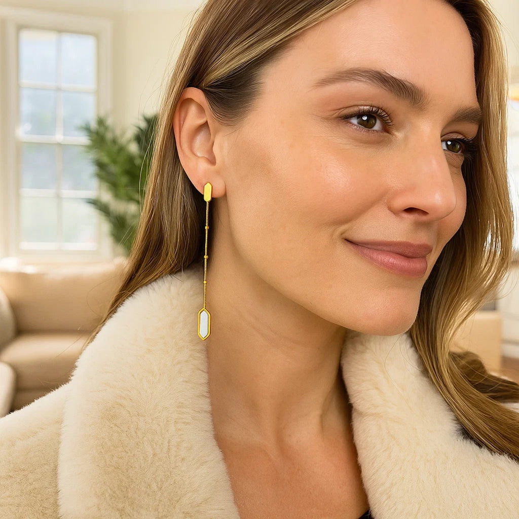 14K yellow gold drop earrings featuring lustrous mother of pearl on elegant chain, embodying modern luxury.