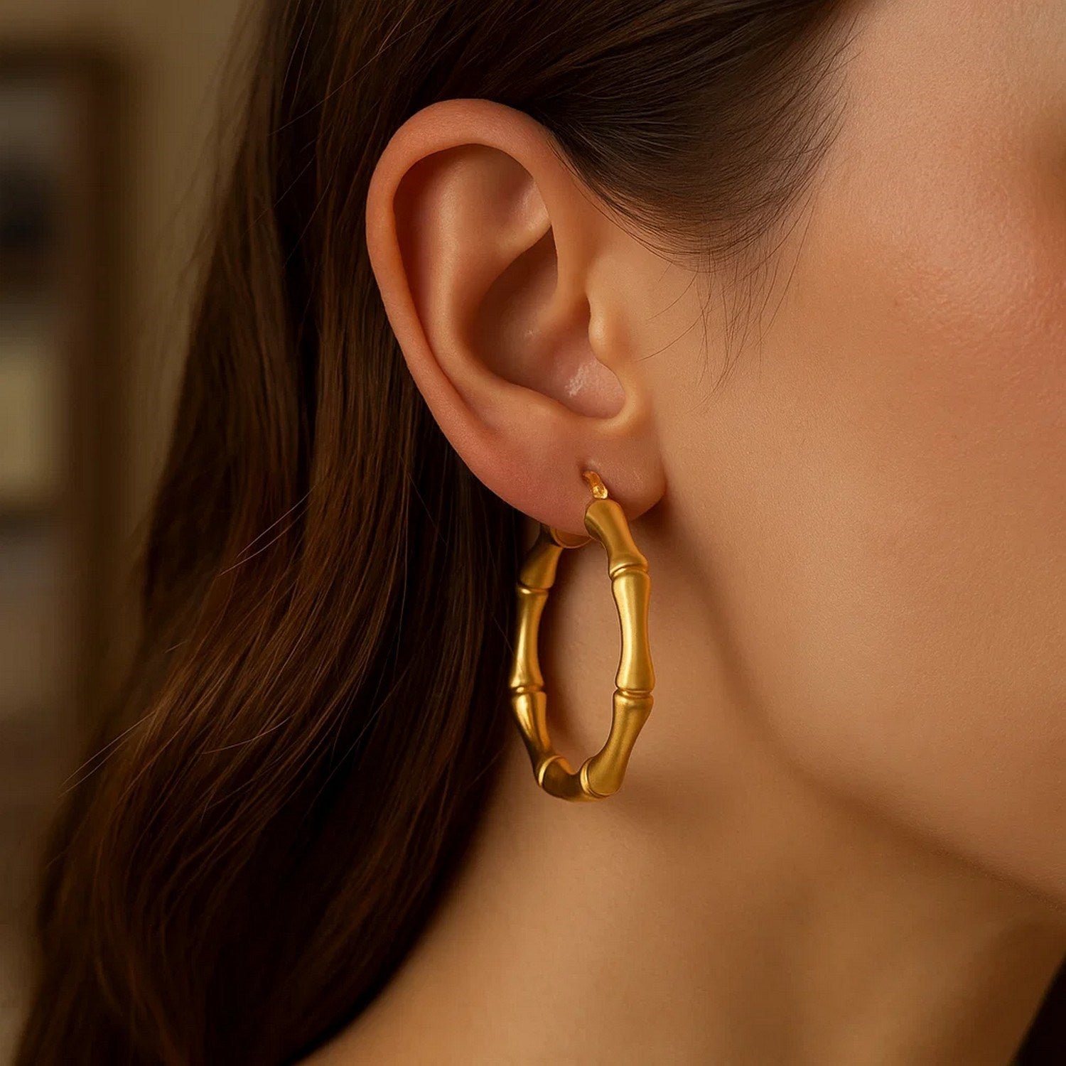 14k yellow gold textured large bamboo hoop earrings, showcasing modern elegance and luxurious craftsmanship.