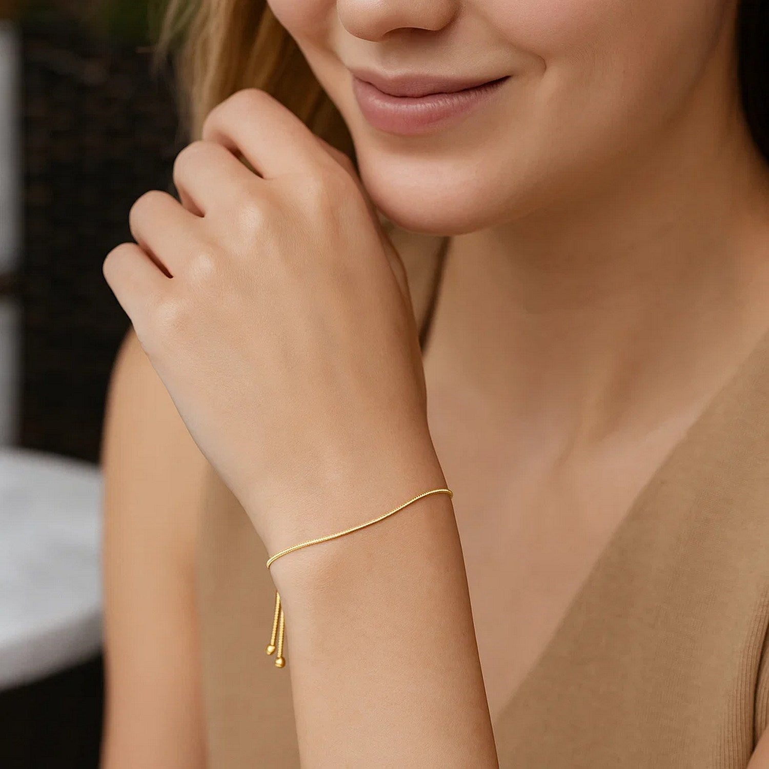 14k yellow gold adjustable lariat bracelet featuring a modern heart motif and delicate chain design.