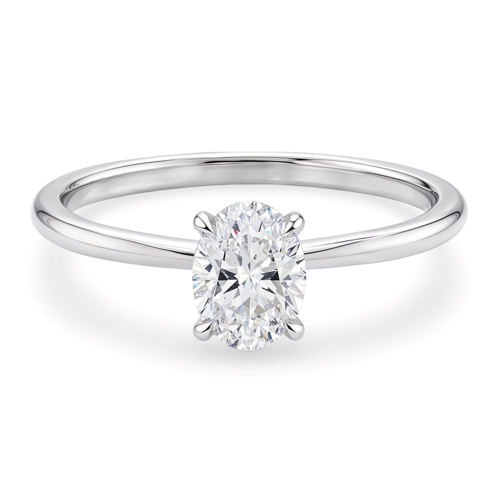 Elegant 10K white gold solitaire ring featuring a 1 carat oval lab-grown diamond in a stunning halo setting.