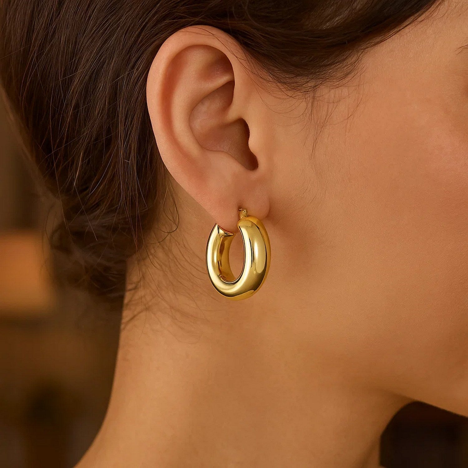 14k yellow gold polished medium hoop earrings with a sleek modern design, perfect for elegant everyday wear.