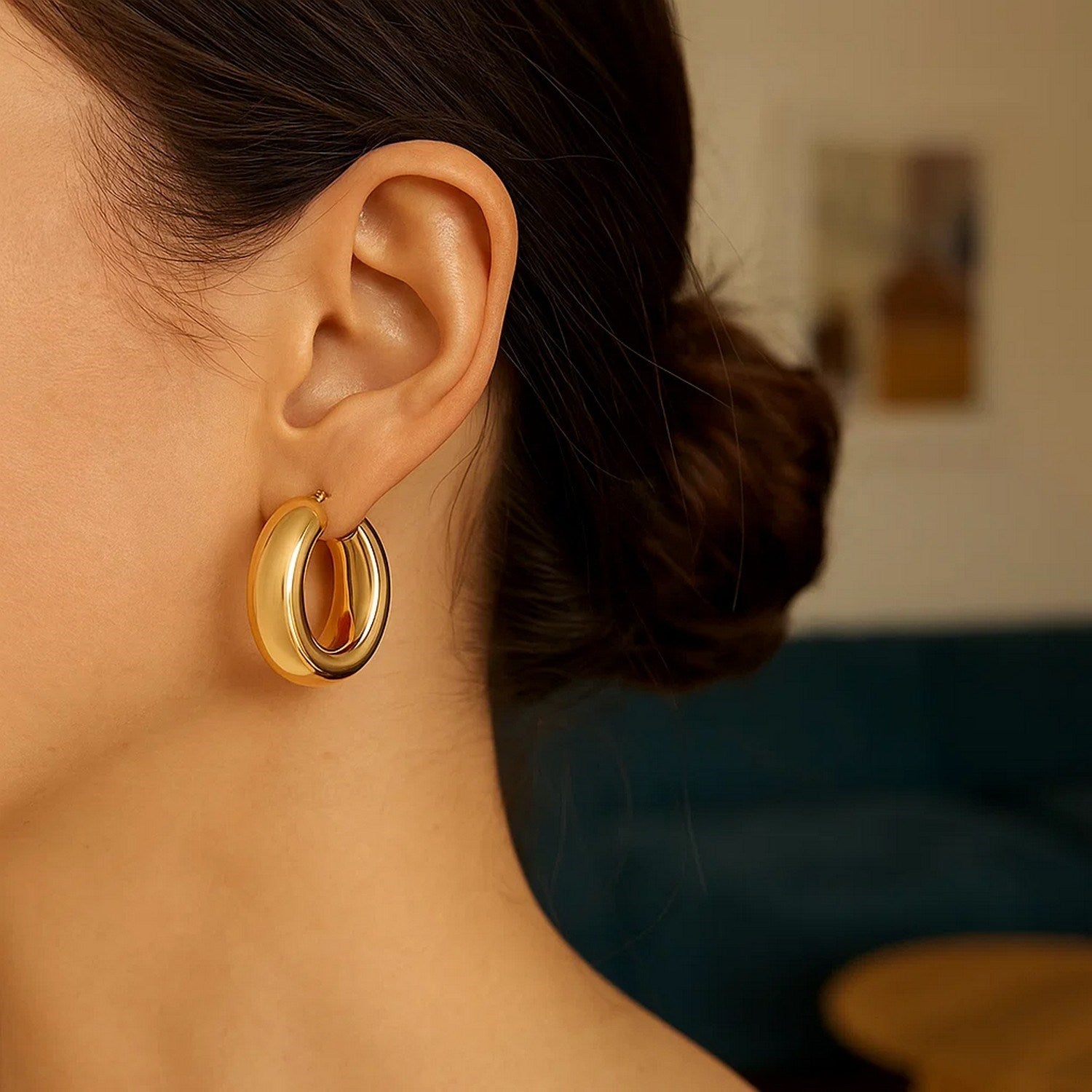 14k yellow gold polished medium hoop earrings with a sleek modern design, perfect for elegant everyday wear.