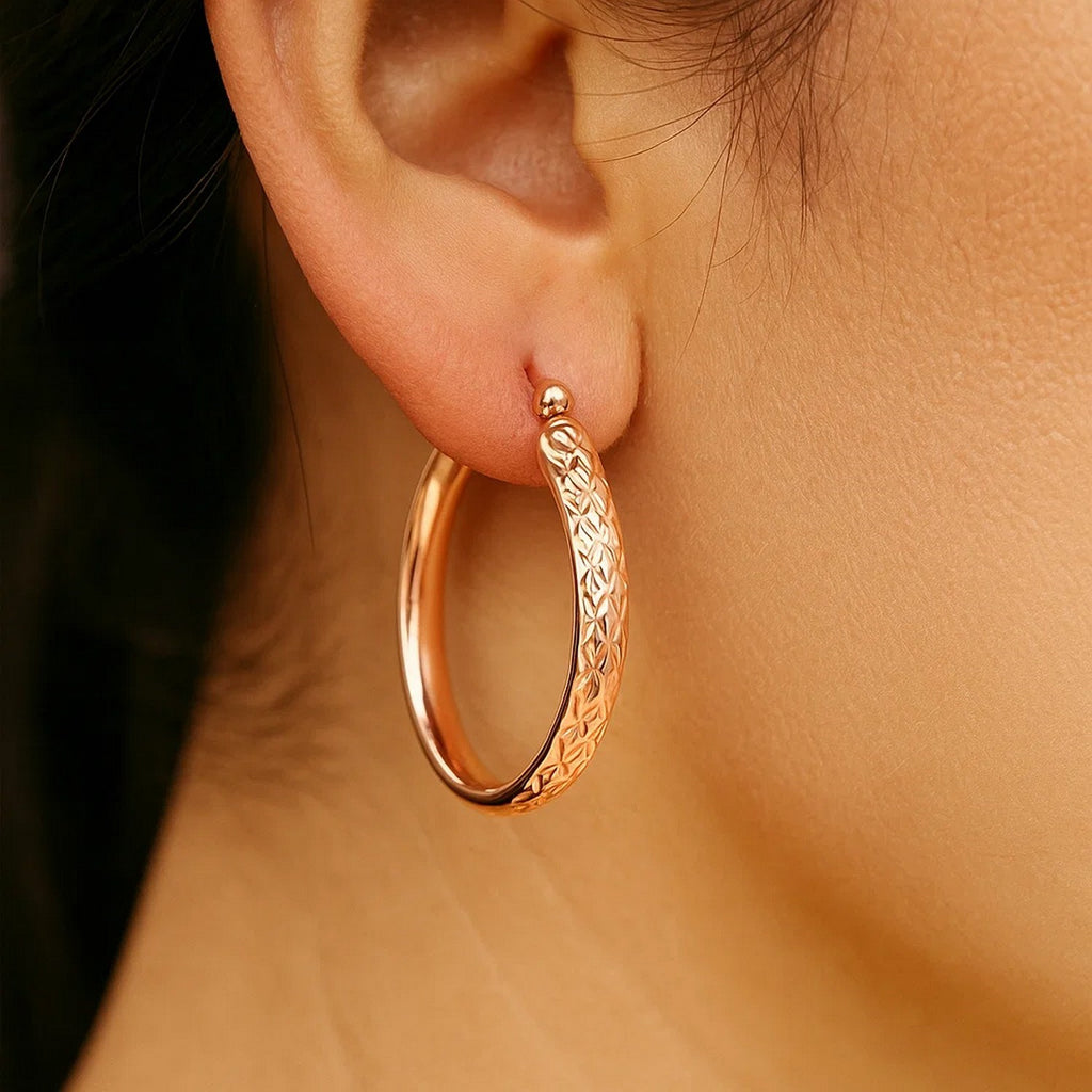 14k rose gold hammered oval hoop earrings with a contemporary design, perfect for elegant everyday wear.