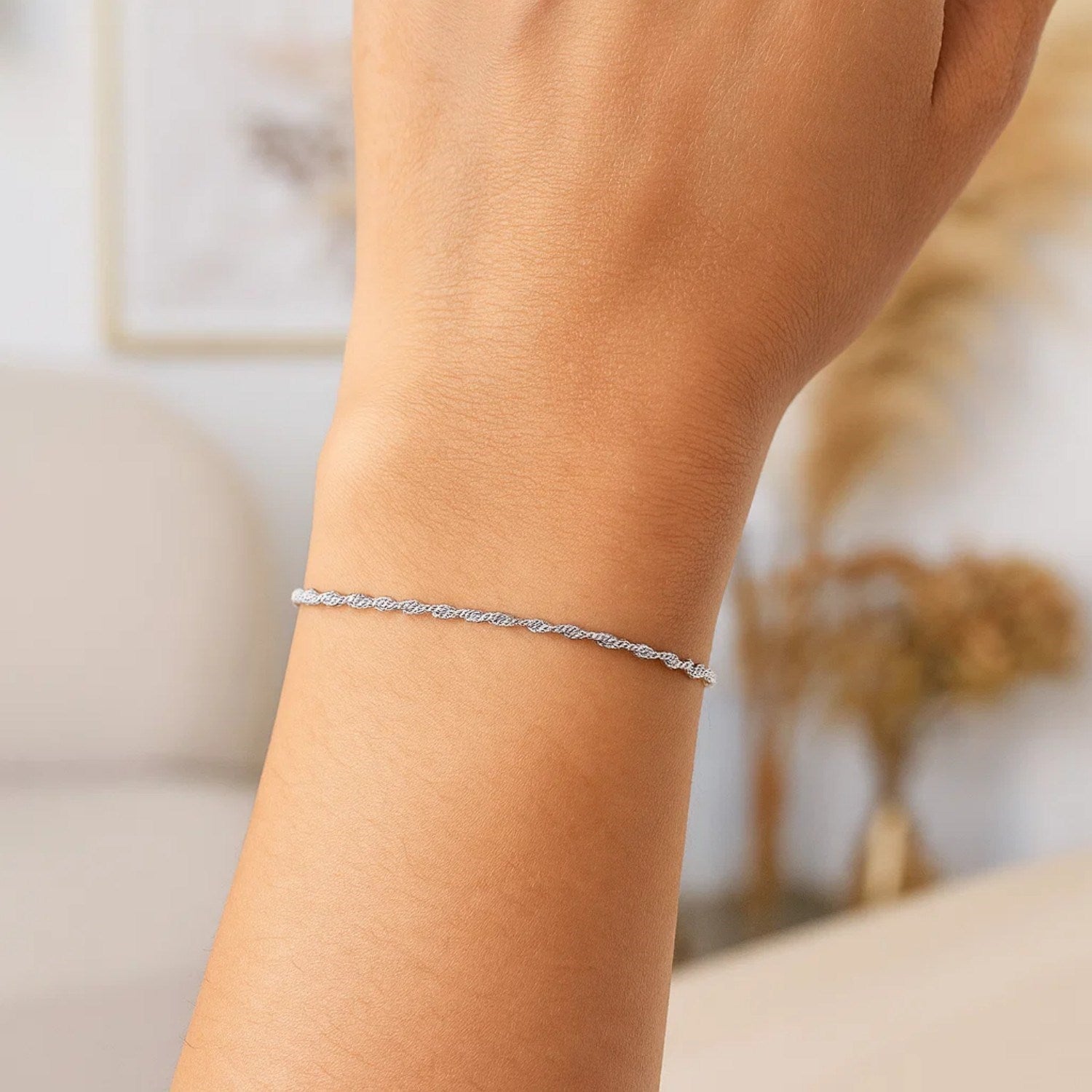 14k white gold Singapore bracelet featuring a modern chain design with elegant stud accents.