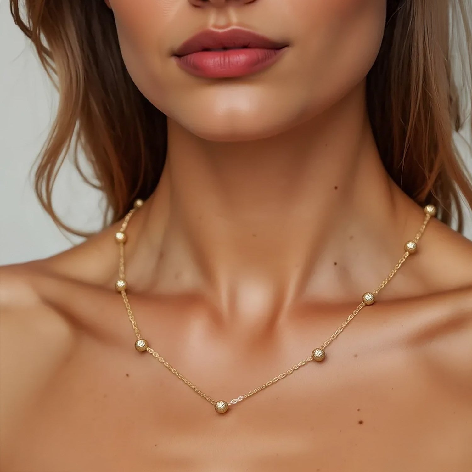 Textured Saturn bead necklace in 14k yellow gold, featuring a modern round chain design for a luxurious touch.
