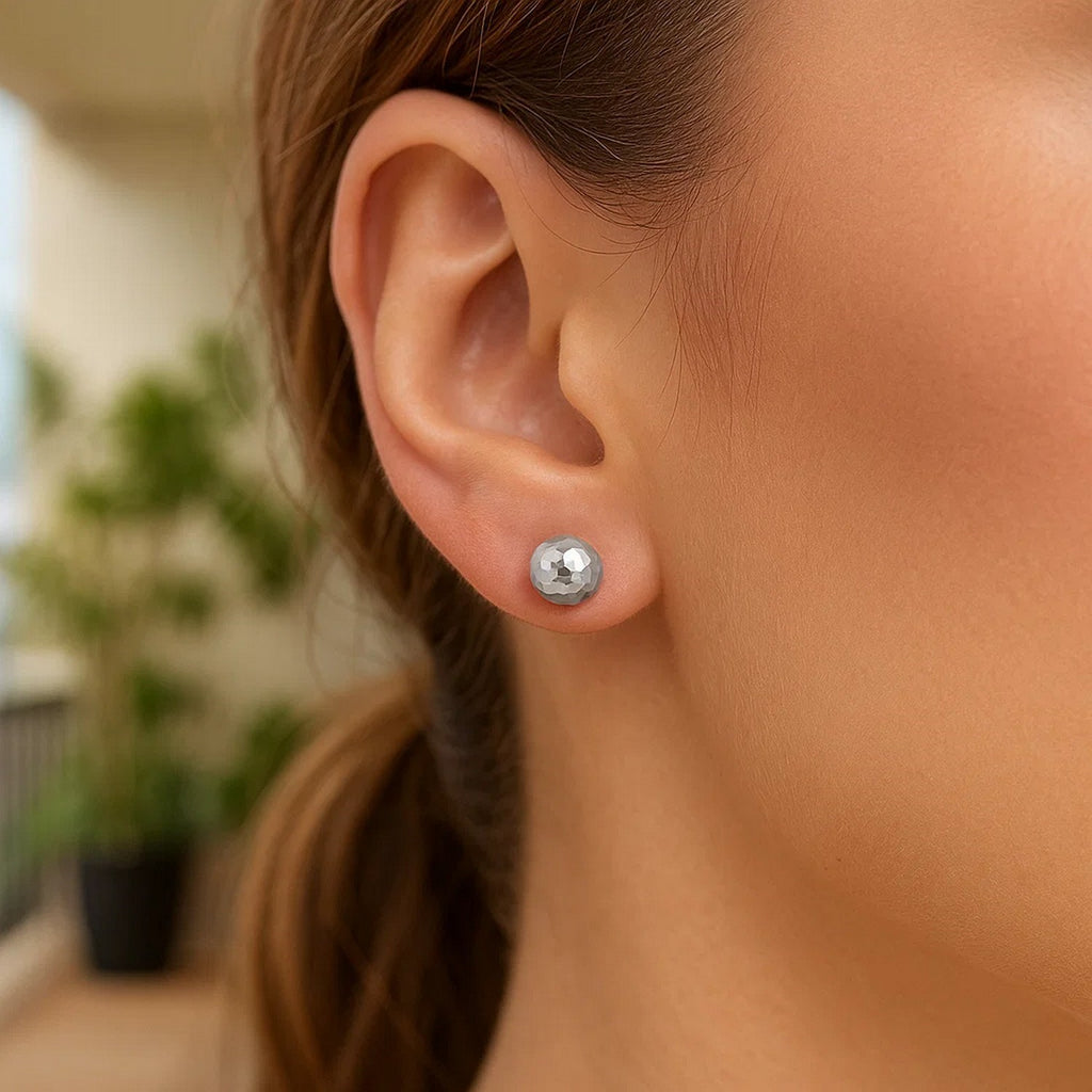 Contemporary 14k white gold faceted ball stud earrings, showcasing a sleek and elegant design for refined style.