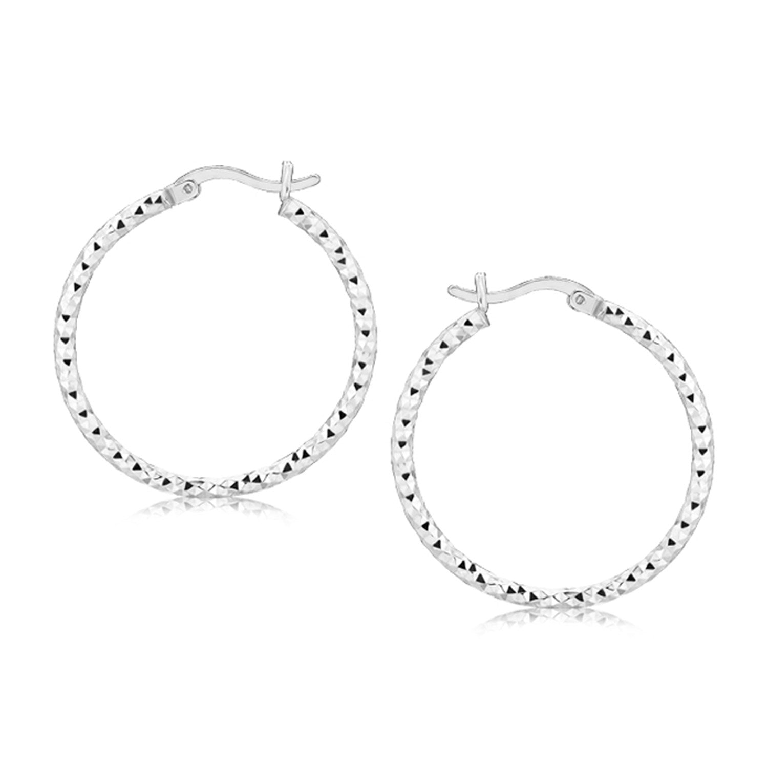 Sterling silver faceted motif hoop earrings with rhodium plating, showcasing modern elegance and refined craftsmanship.