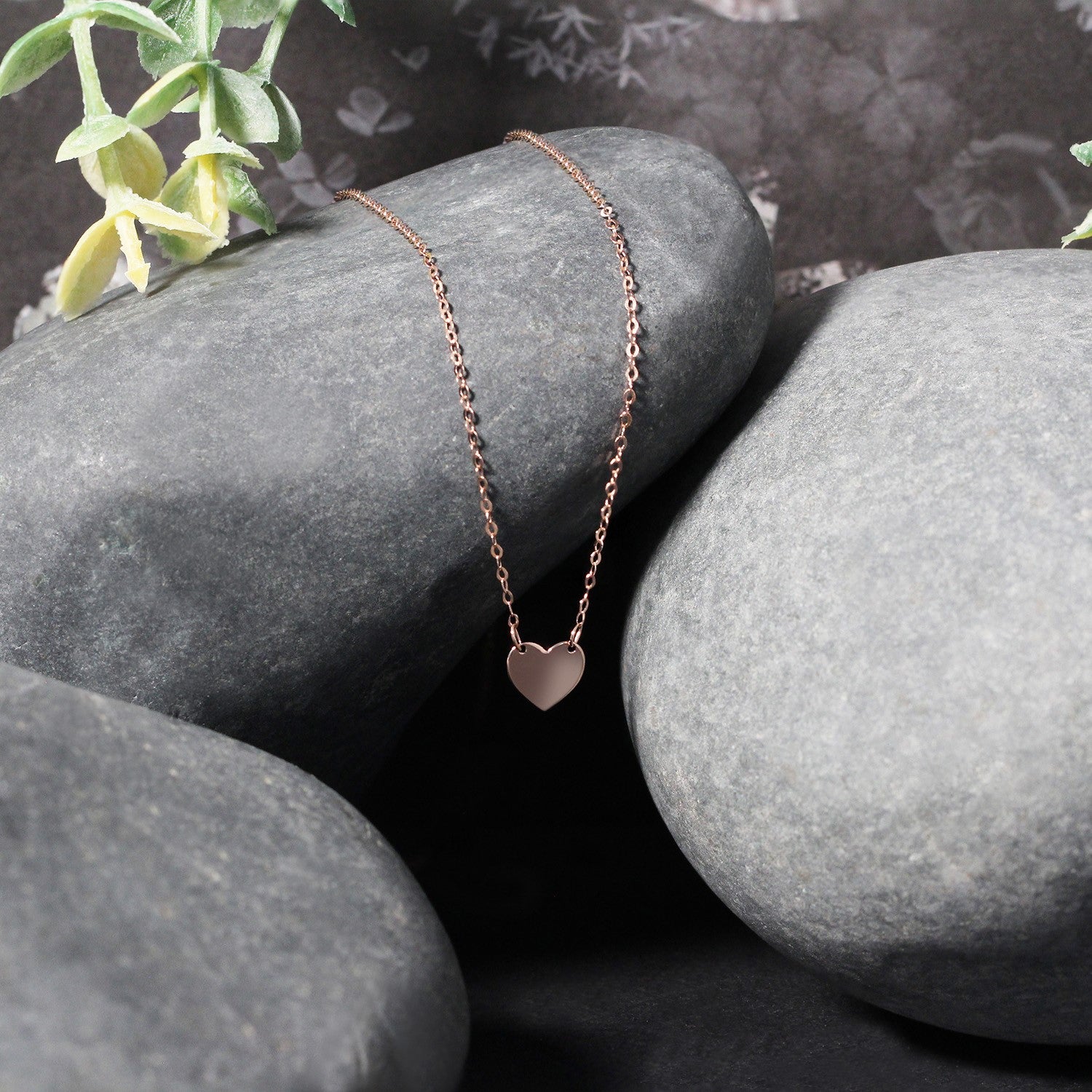 14k rose gold polished mini heart necklace with delicate chain, embodying classic elegance and timeless charm.