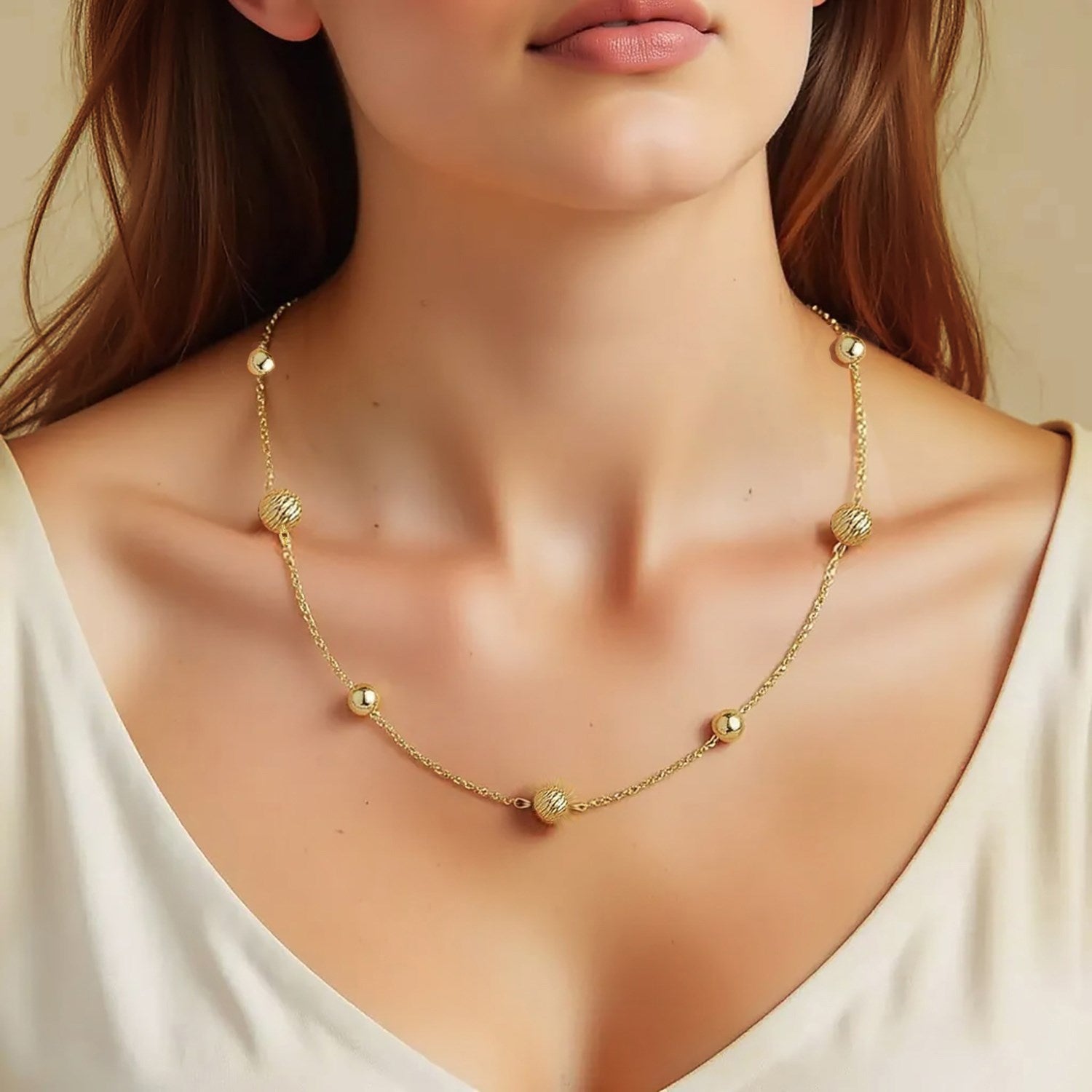 Elegant 14k yellow gold alternating bead chain necklace adorned with sparkling diamonds, showcasing refined luxury.