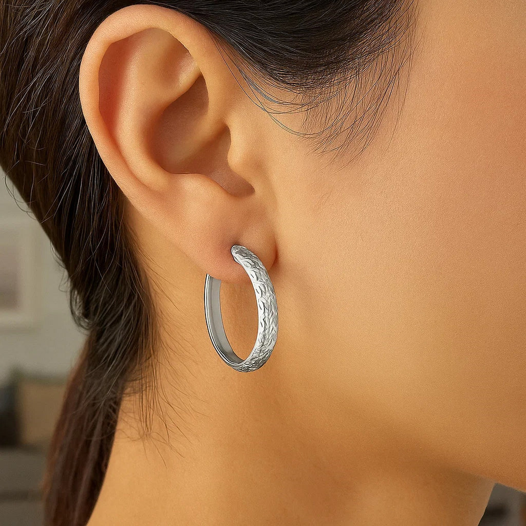 14k white gold hammered oval hoop earrings showcasing modern elegance and refined craftsmanship.