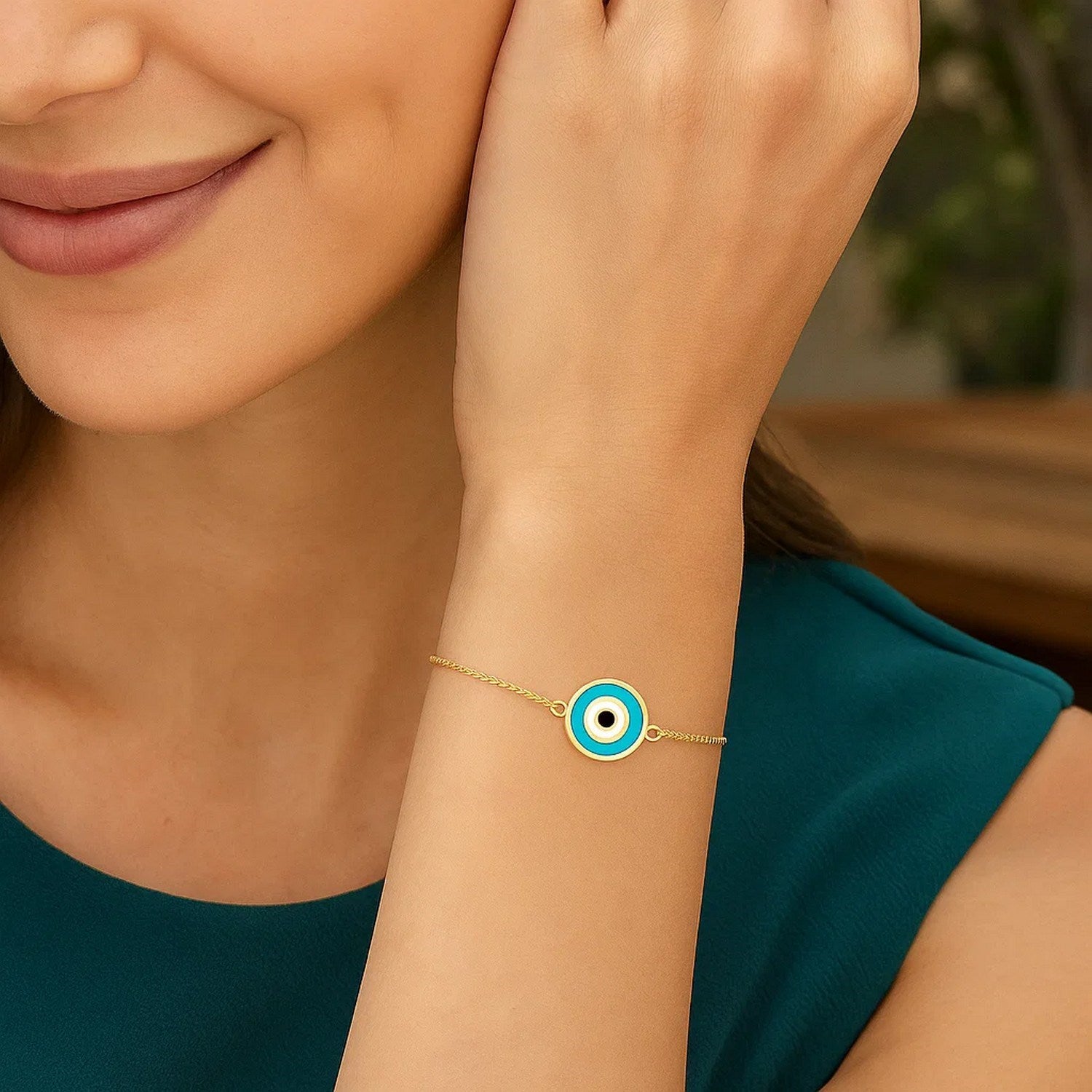 14k yellow gold modern bracelet featuring a cushion cut blue evil eye on a delicate chain design.