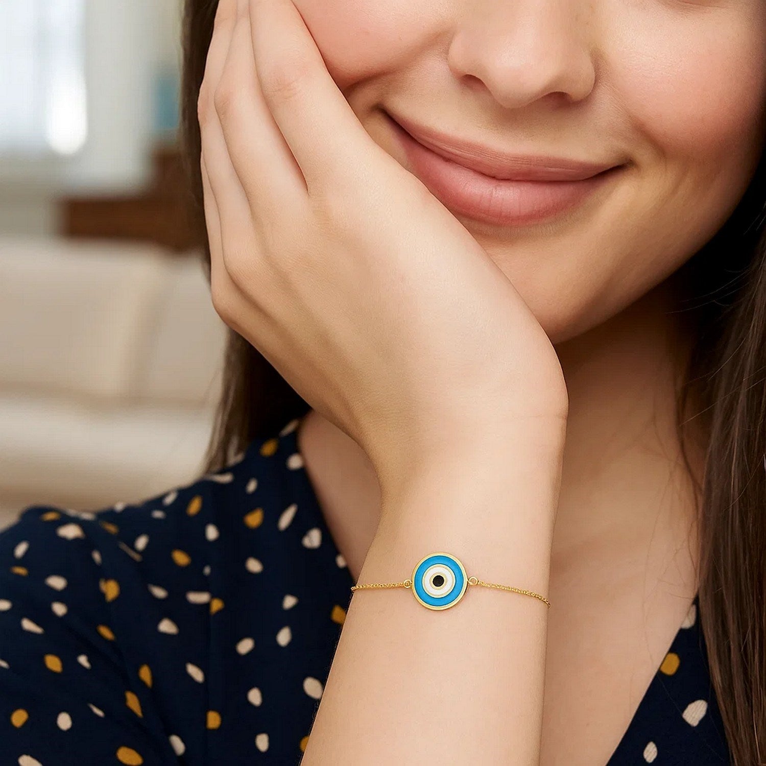 14k yellow gold modern bracelet featuring a cushion cut blue evil eye on a delicate chain design.