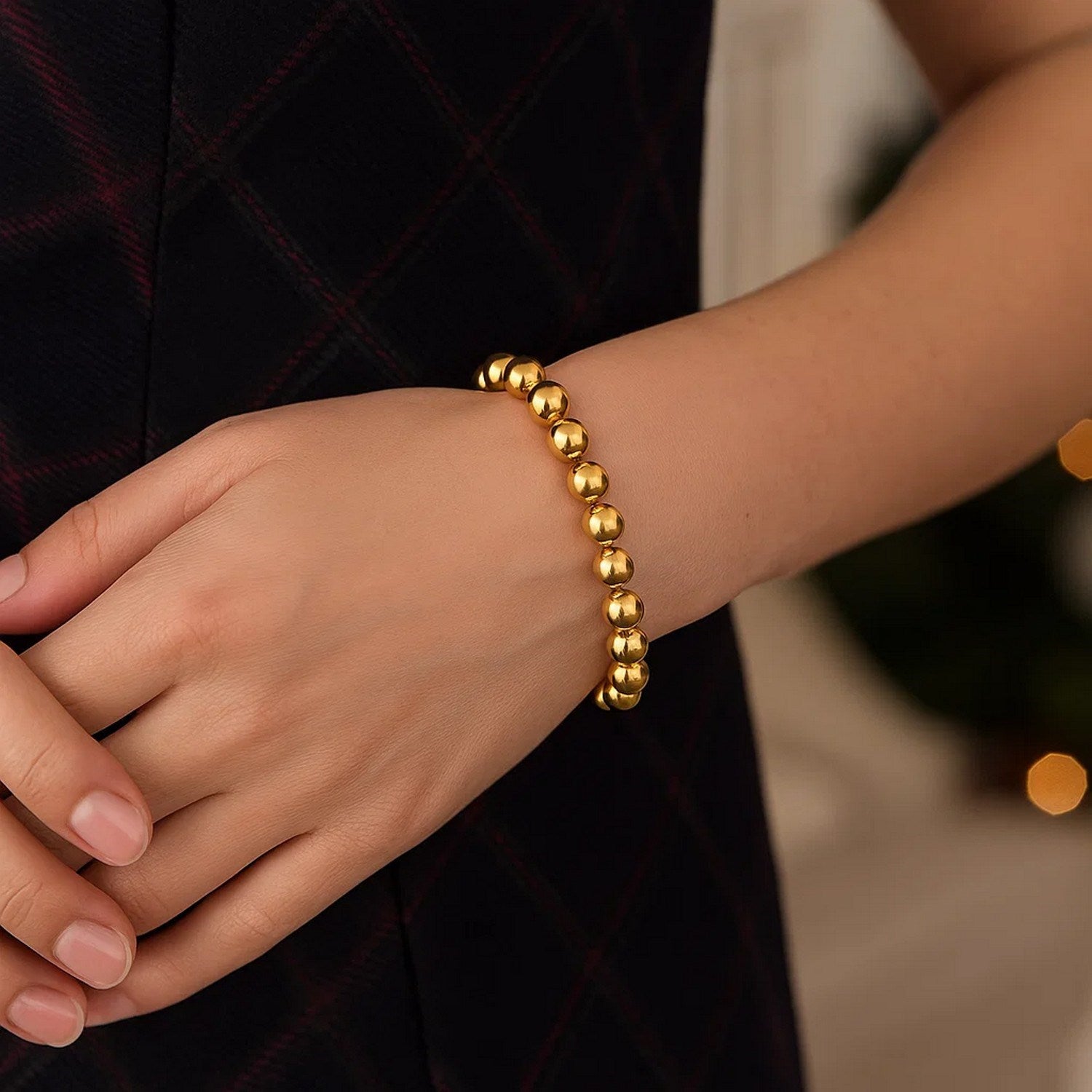 Polished 8mm bead bracelet in luxurious 14k yellow gold, showcasing elegant craftsmanship and timeless style.
