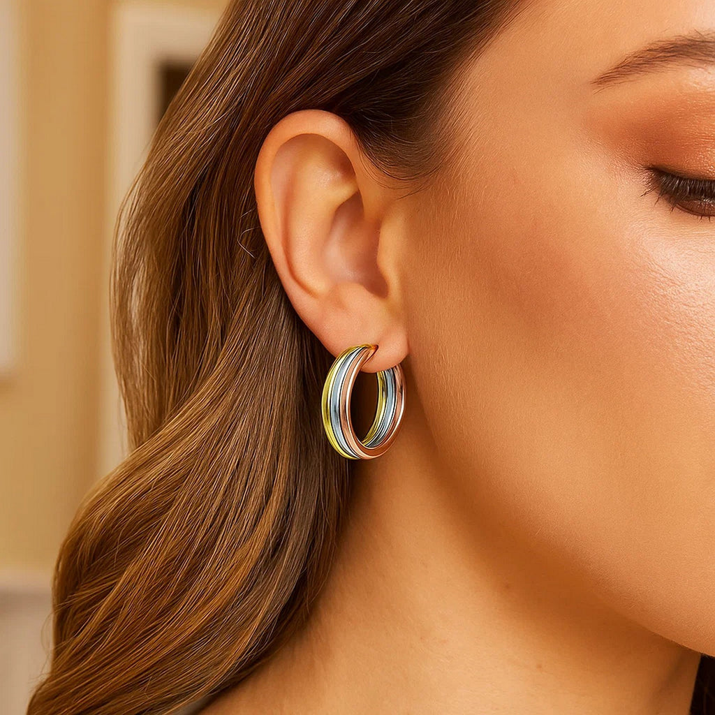 14K tri-color gold polished tube hoop earrings showcasing an elegant design and luxurious shine.