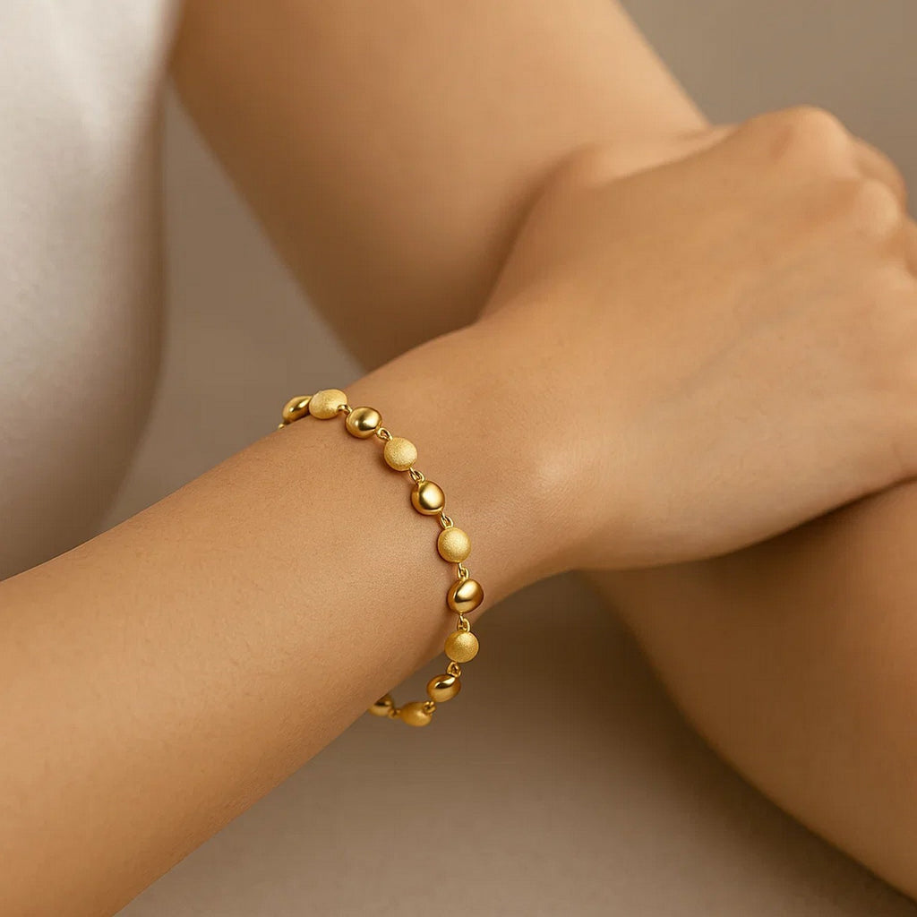 14k yellow gold polished and satin pebble bracelet, elegantly designed with a luxurious finish, perfect for any occasion.