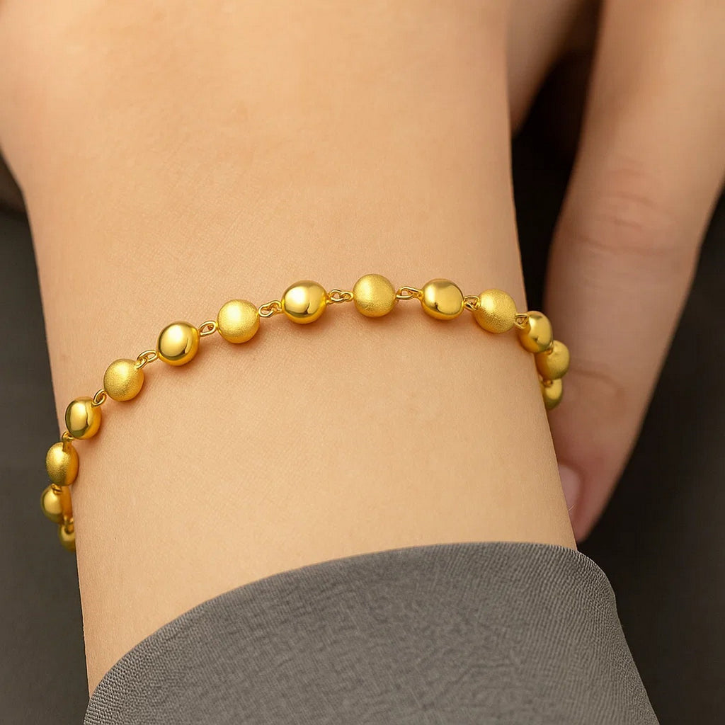 Elegant 14k yellow gold polished and satin pebble bracelet, showcasing a luxurious 6.00 mm design for refined style.