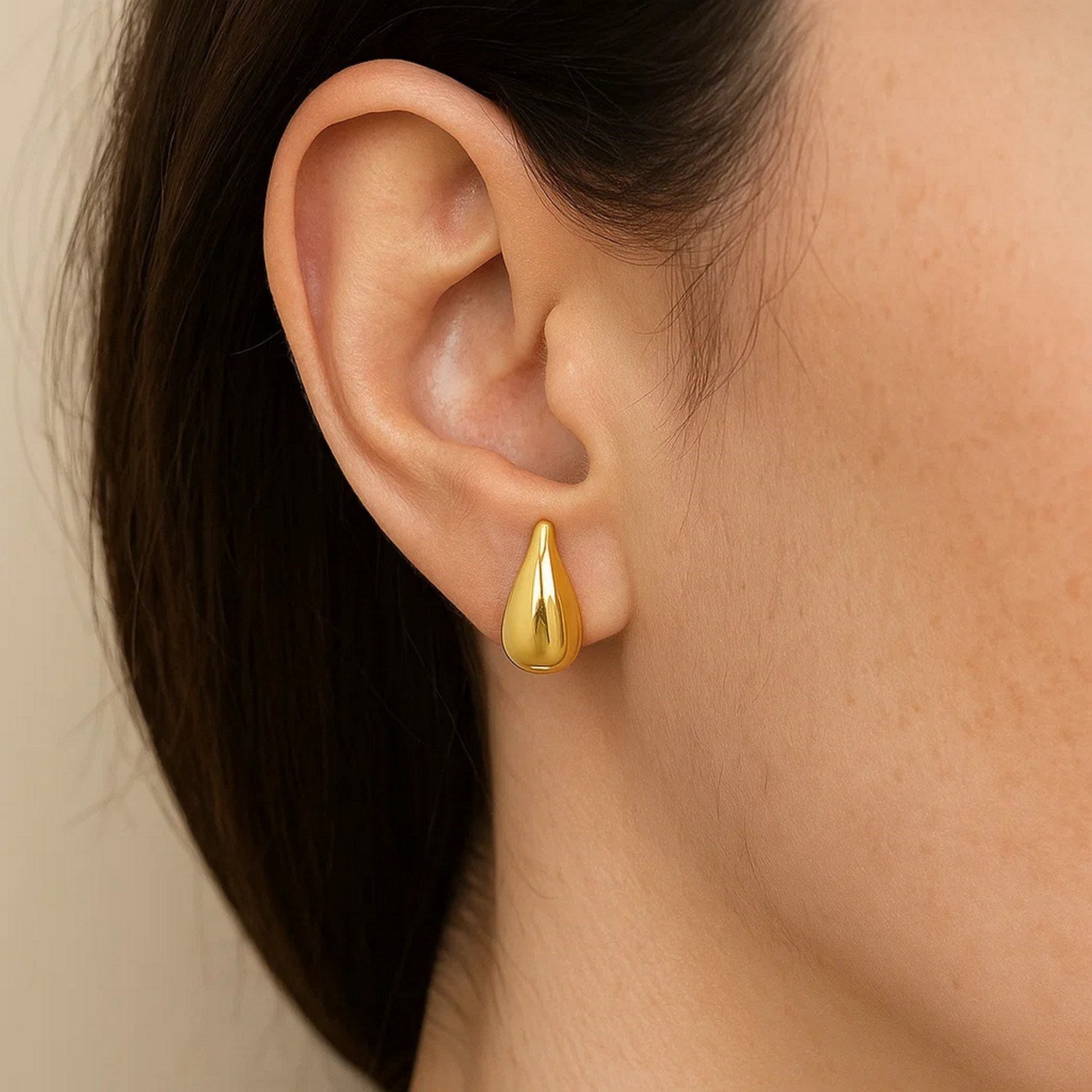 14k yellow gold small raindrop stud earrings featuring a modern drop design, perfect for elegant everyday wear.