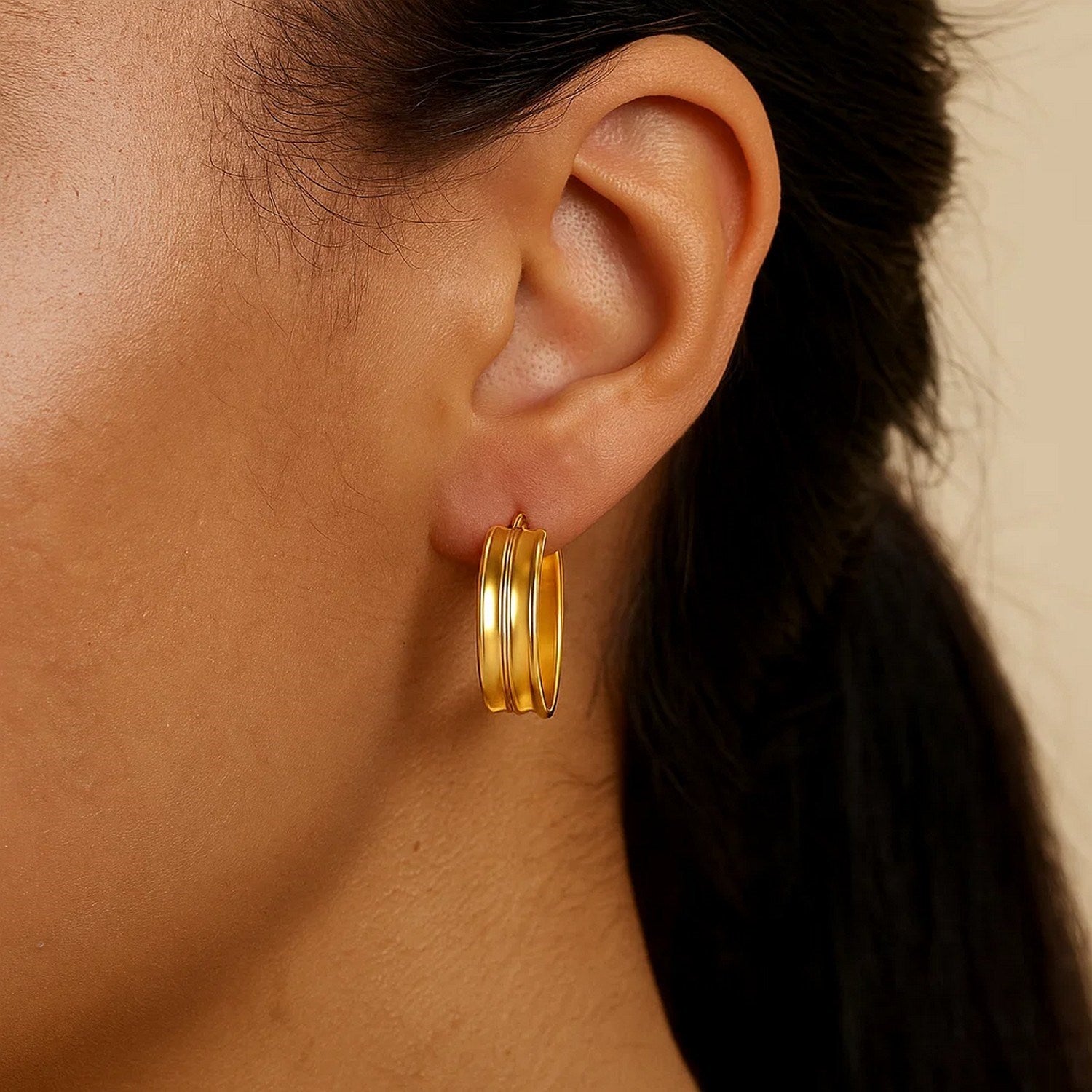 14k yellow gold polished large concave hoop earrings with a modern design, perfect for elegant occasions.
