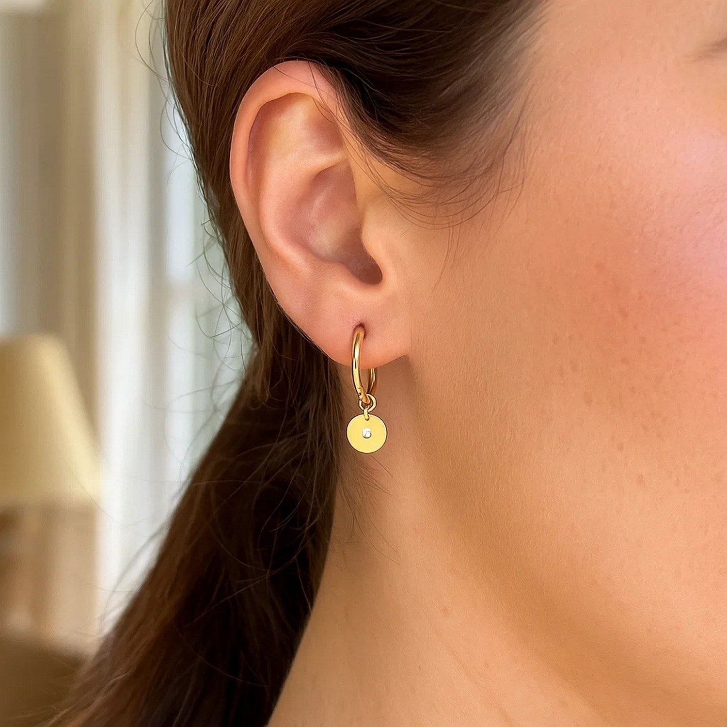 14k yellow gold hoop earrings featuring sparkling diamond disc charms in a modern design.