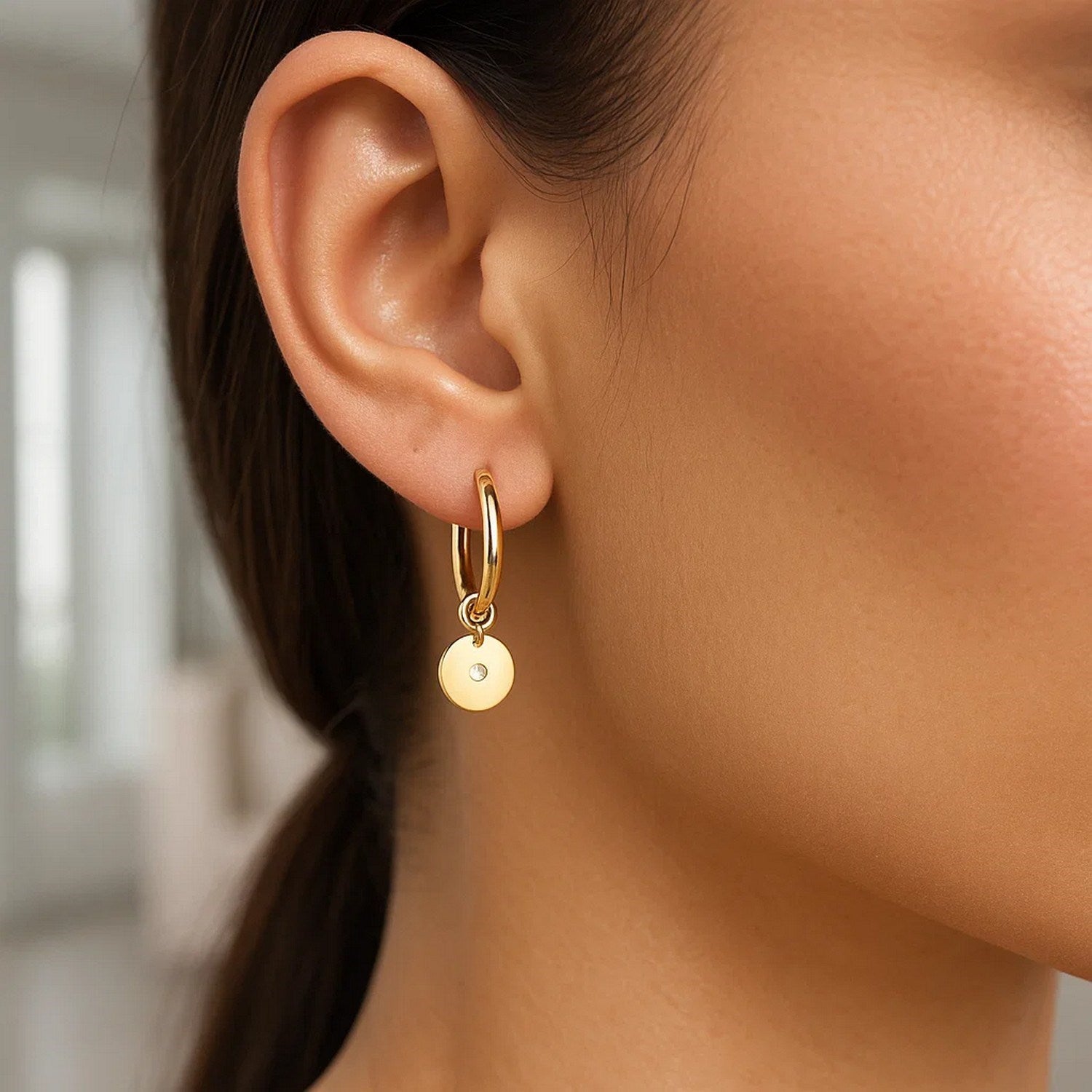 14K yellow gold hoop earrings featuring a modern design with sparkling diamond disc charms for a luxurious touch.
