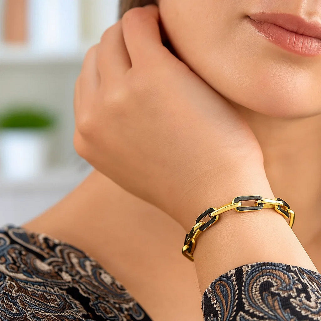 14k yellow gold black onyx paperclip link bracelet with modern design, showcasing elegance and sophistication.