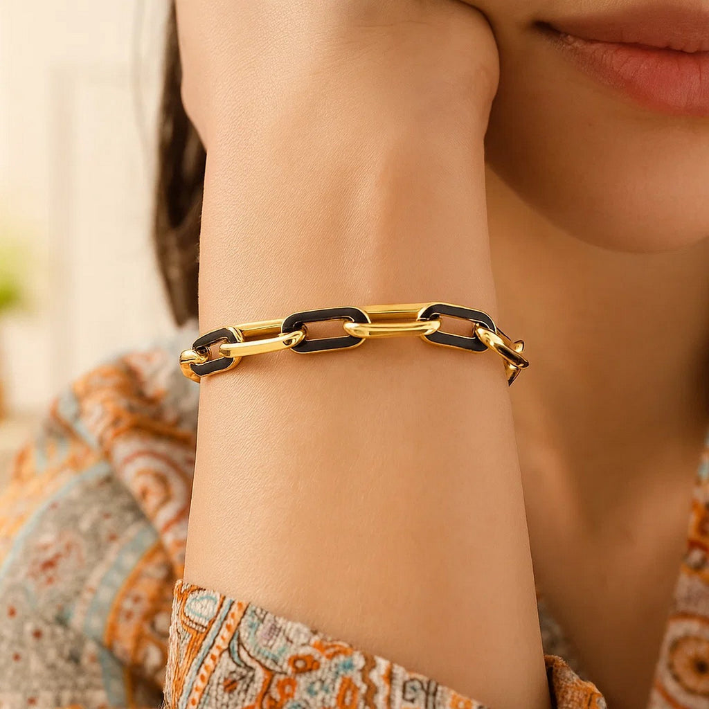 14k yellow gold modern paperclip bracelet featuring elegant black onyx links, perfect for sophisticated styling.