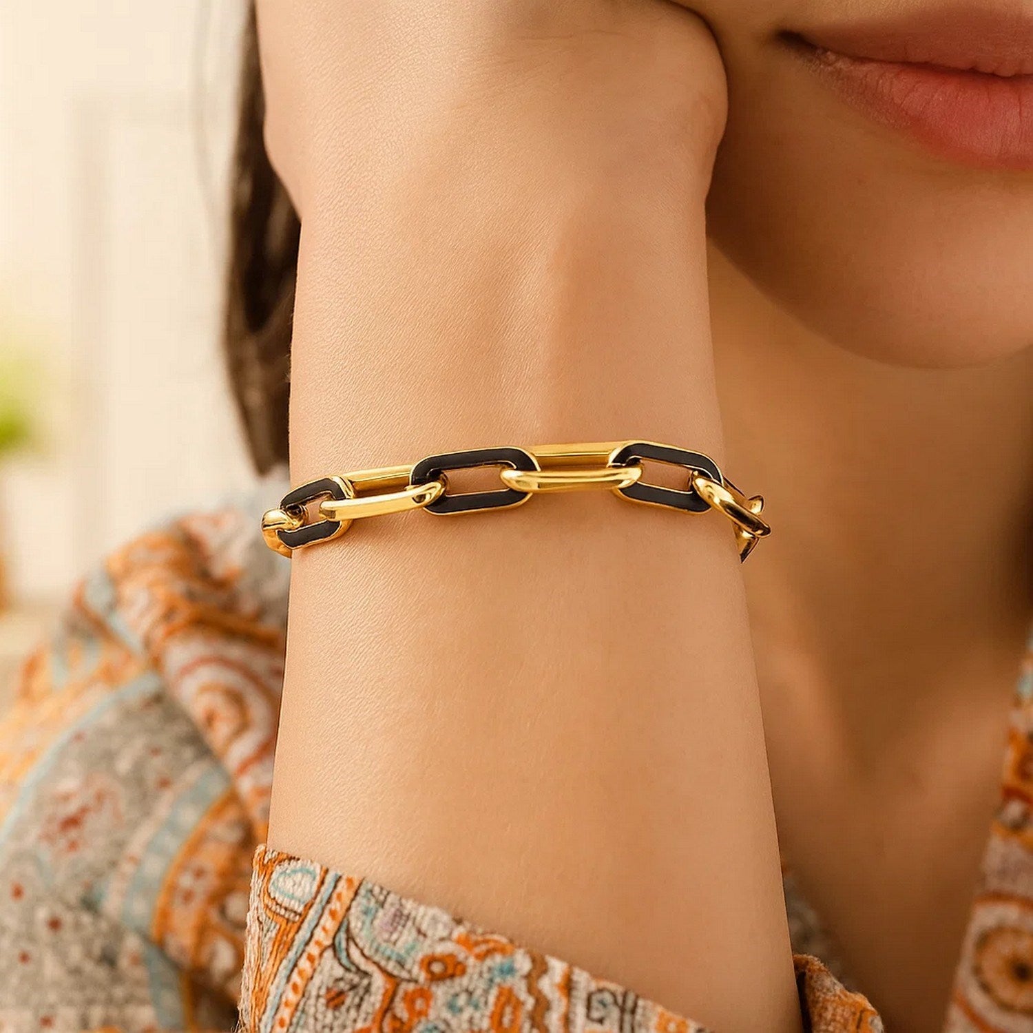 14k yellow gold modern paperclip bracelet featuring elegant black onyx links, perfect for sophisticated styling.