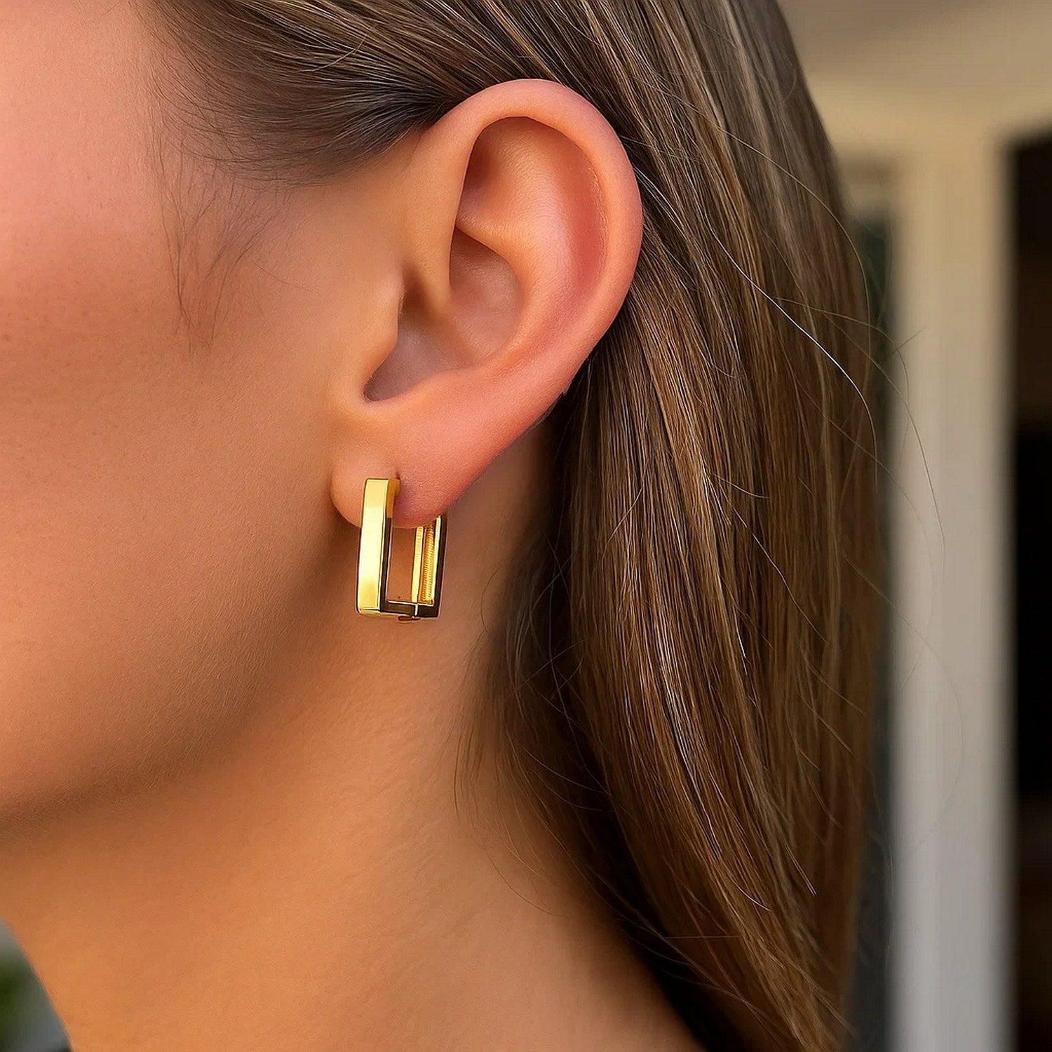 14k yellow gold polished hoop huggie earrings with a sleek modern design, perfect for elegant everyday wear.