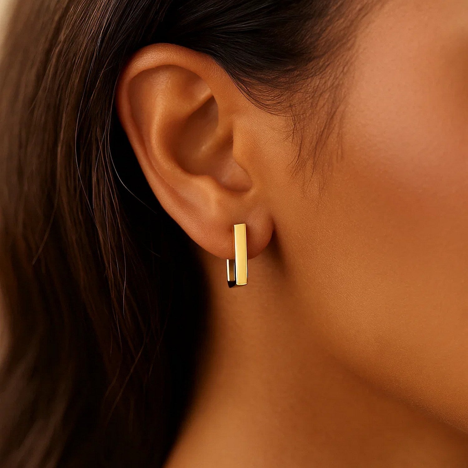 14k yellow gold polished hoop huggie earrings with a modern design, perfect for elegant everyday wear.