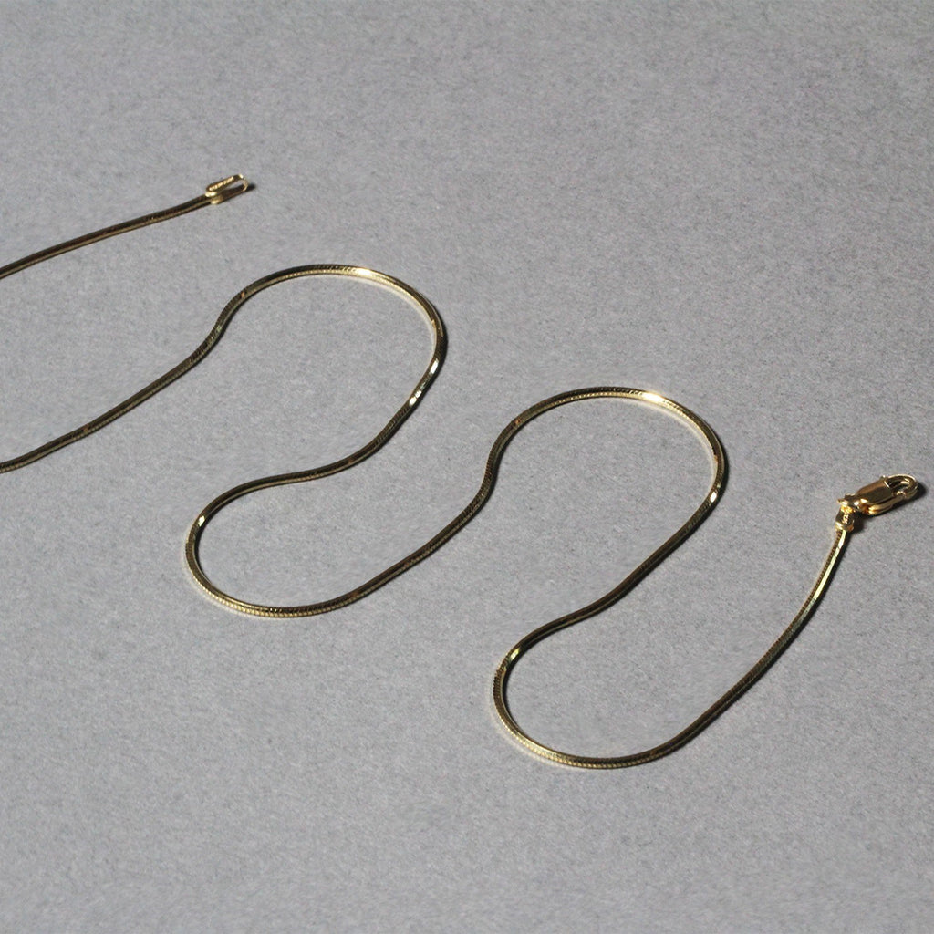 14k yellow gold octagonal shiny snake chain with a modern design, perfect for layering or standalone elegance.