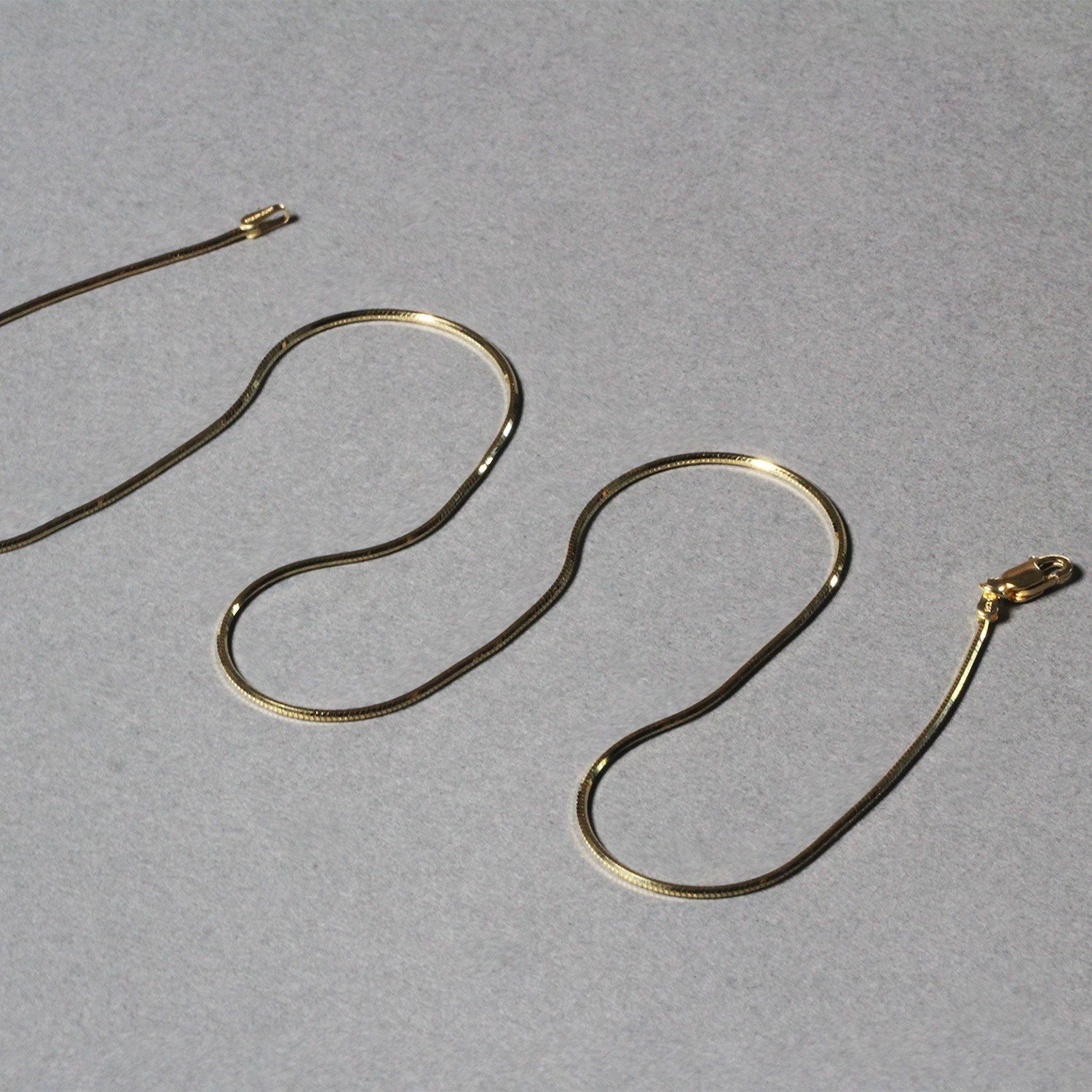 14k yellow gold octagonal shiny snake chain with a modern design, perfect for layering or standalone elegance.