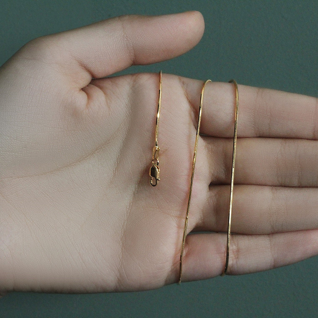 14k yellow gold octagonal shiny snake chain with a modern design, perfect for layering or standalone elegance.