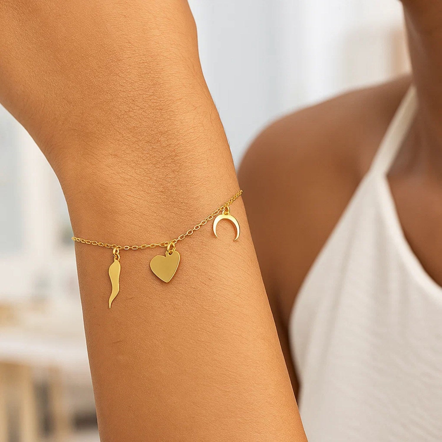 14k yellow gold modern bracelet featuring polished charms on a delicate chain, perfect for elegant layering.